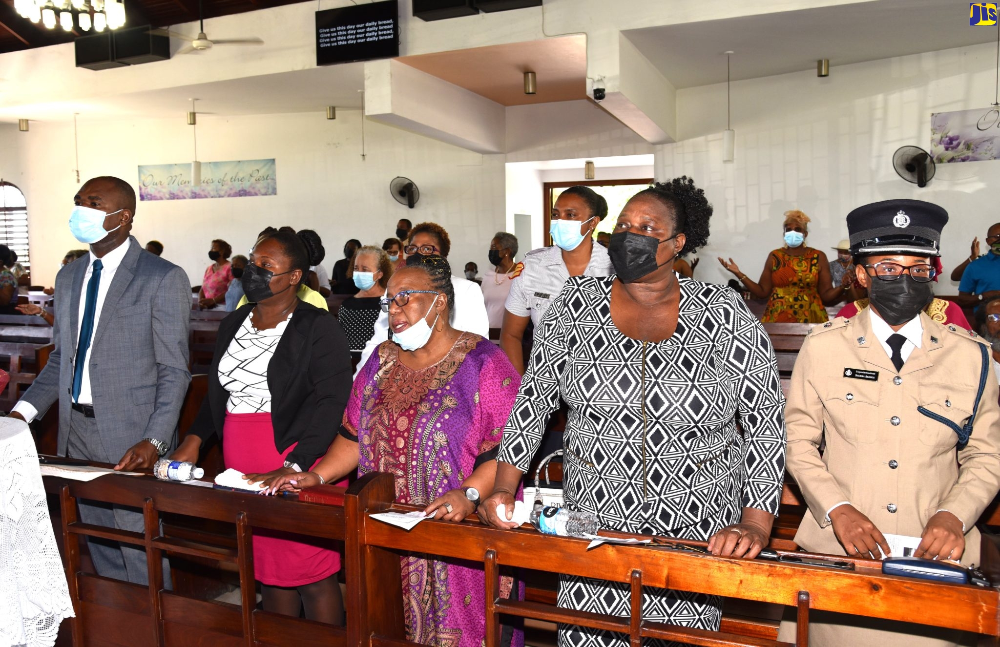 Minister of State in the Ministry of National Security, Hon. Zavia Mayne (left), joins other congregants in singing a hymn during the National Neighbourhood Watch Movement’s 35th anniversary church service, which was held at the Church of the Transfiguration in St. Andrew, on November 6. With Mr. Mayne (from second left) are: Police Woman Constable Tavia Bryan; President, St. Andrew North Neighbourhood Watch Council, Opal Davis; Woman Inspector Karen Salmon; and Commanding Officer, St. Andrew North Police Division, Superintendent Sherika Service.