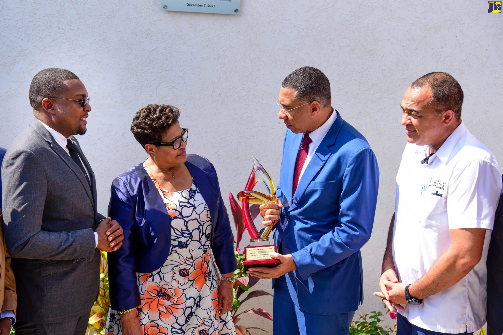 Prime Minister, the Most Hon. Andrew Holness (second right) presents Jamaican businesswoman/philanthropist, Beverly Nichols (second left), with a token during the ceremony for the reopening of the Chapelton Community Hospital on December 6. Looking on are, from left, Minister without Portfolio in the Office of the Prime Minister with Responsibility for Information, Hon. Robert Morgan, who is also Member of Parliament for Clarendon North Central; and Minister of Health and Wellness, Dr. the Hon. Christopher Tufton. 


