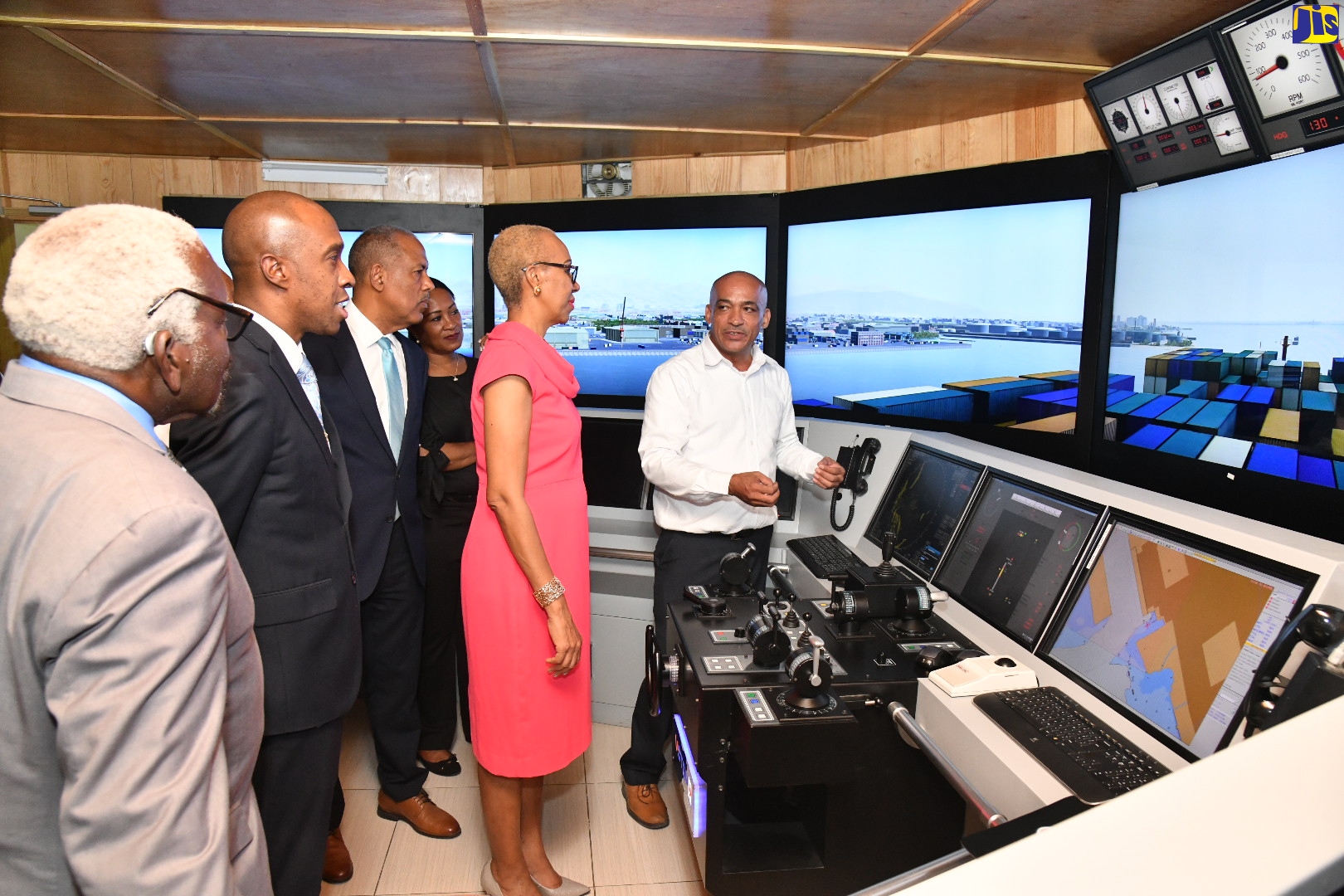 Minister of Education and Youth, Hon. Fayval Williams (second right), looks on as Simulator Instructor, Caribbean Maritime University (CMU), Derrick McLennon (right), explains the features of the stimulator used in maritime training, during a tour of the university in Kingston on Tuesday (December 6). Others (from left) are former Speaker of the House of Representatives, Pearnel Charles; President, CMU, Professor Andrew Spencer; Chairman, CMU, Professor Gordon Shirley; and Manager, Corporate Communication and Public Relations, Ministry of Education and Youth, Sheryl Bromfield. 

