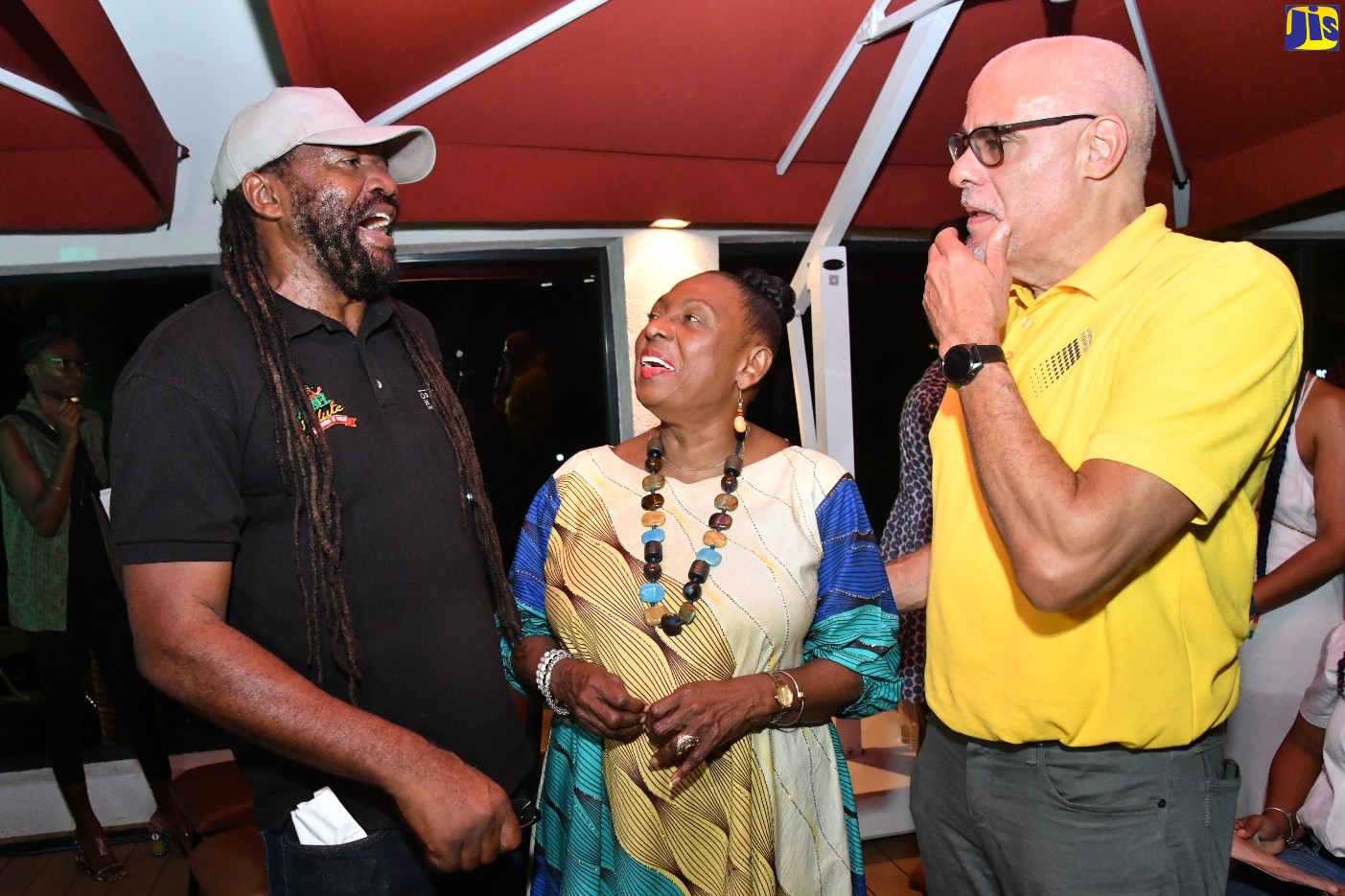 Minister of Culture, Gender, Entertainment and Sport, Hon. Olivia Grange (centre), engages in conversation with Rebel Salute conceptualiser, Tony Rebel (left); and Group Chief Executive Officer, JMMB, Keith Duncan. They were at the 2023 Rebel Salute media launch on Wednesday (December 21), at the ROK Hotel, downtown Kingston.