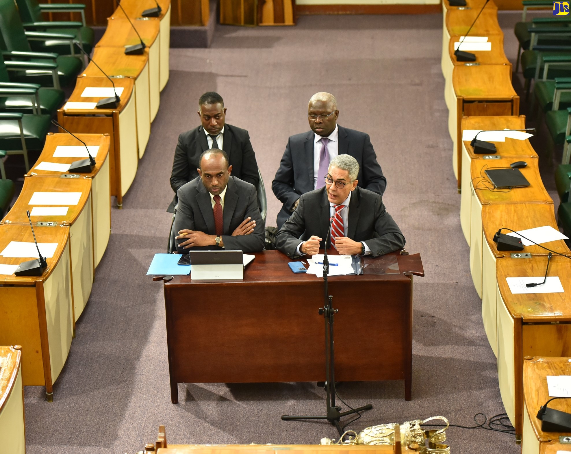 Bank of Jamaica (BOJ) Governor, Richard Byles (right, foreground), delivers a monetary policy statement during a recent meeting of the Standing Finance Committee of the House of Representatives, at Gordon House. With him are Senior Deputy Governor, Dr. Wayne Robinson (left, foreground), and (from left, background) Deputy Governors, Dr. Jide Lewis and Robert Stennett.