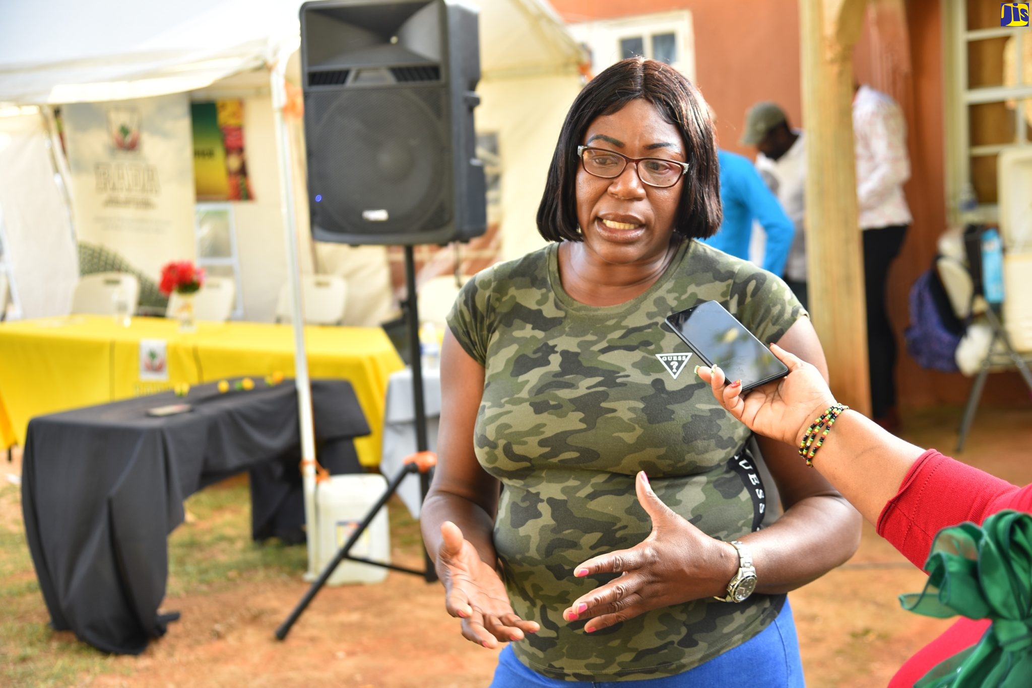 Farmer Barbara Forbes expresses her relief and happiness at the newly paved road in Back Street (Wilderness) in Manchester, which was officially opened by Minister of Agriculture and Fisheries, Hon. Pearnel Charles Jr. on Thursday (Dec. 15).