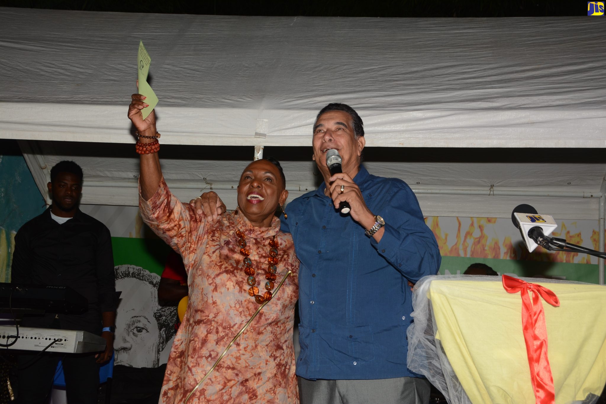 Minister of Culture, Gender, Entertainment and Sport, Hon. Olivia Grange (left) and Minister of State in the Office of the Prime Minister (West), Hon. Homer Davis, are in a celebratory mood during the 2022 Sam Sharpe Flames of Freedom Ceremony and Celebratory Concert at Tulloch Castle in Kensington, St. James, on Wednesday (December 28). 