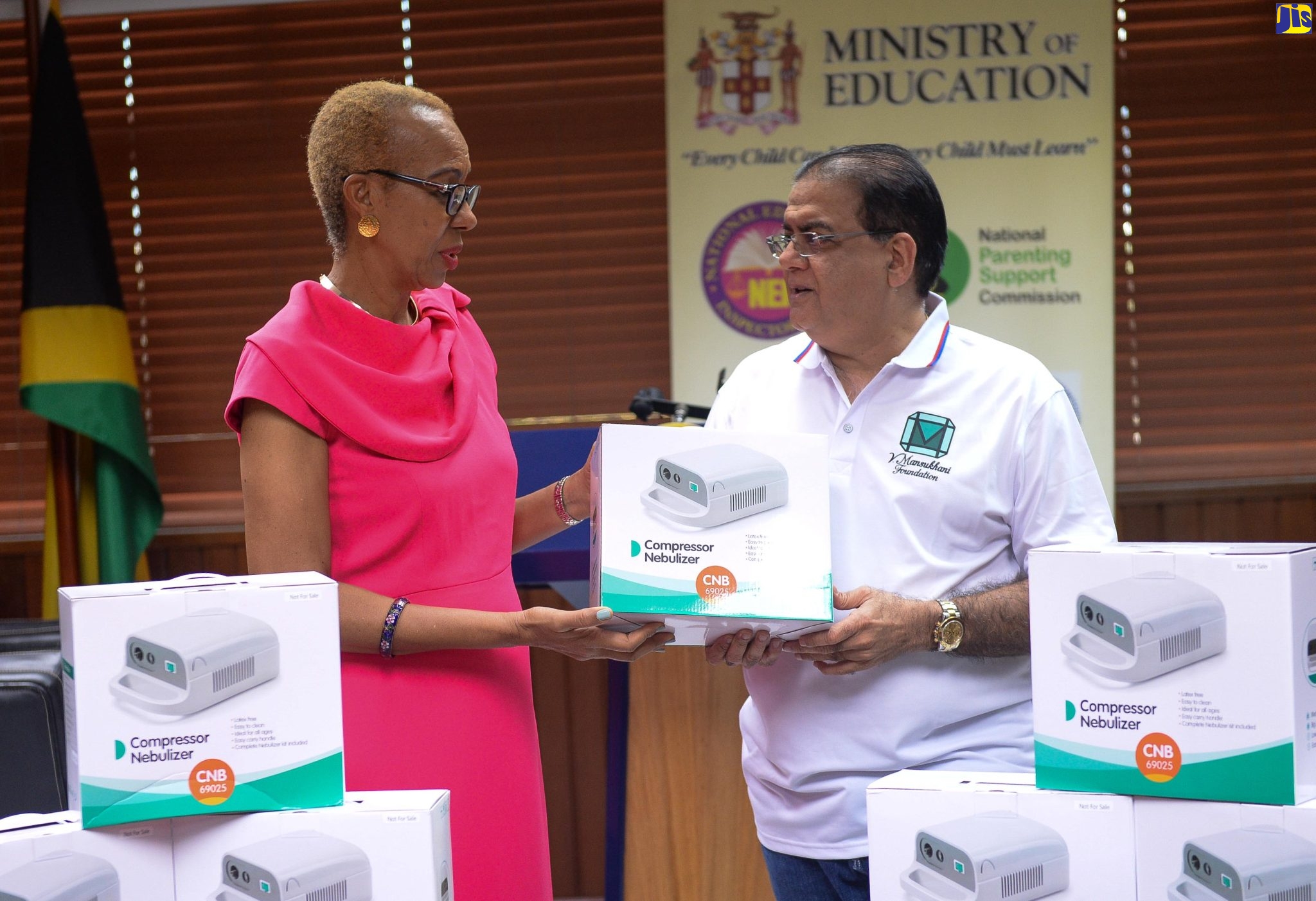 Minister of Education and Youth, Hon. Fayval Williams (left), receives 40 compressor nebulisers from businessman, Gul Mansuhkani, during a recent handover of the machines at the Ministry’s National Heroes Circle offices in Kingston.