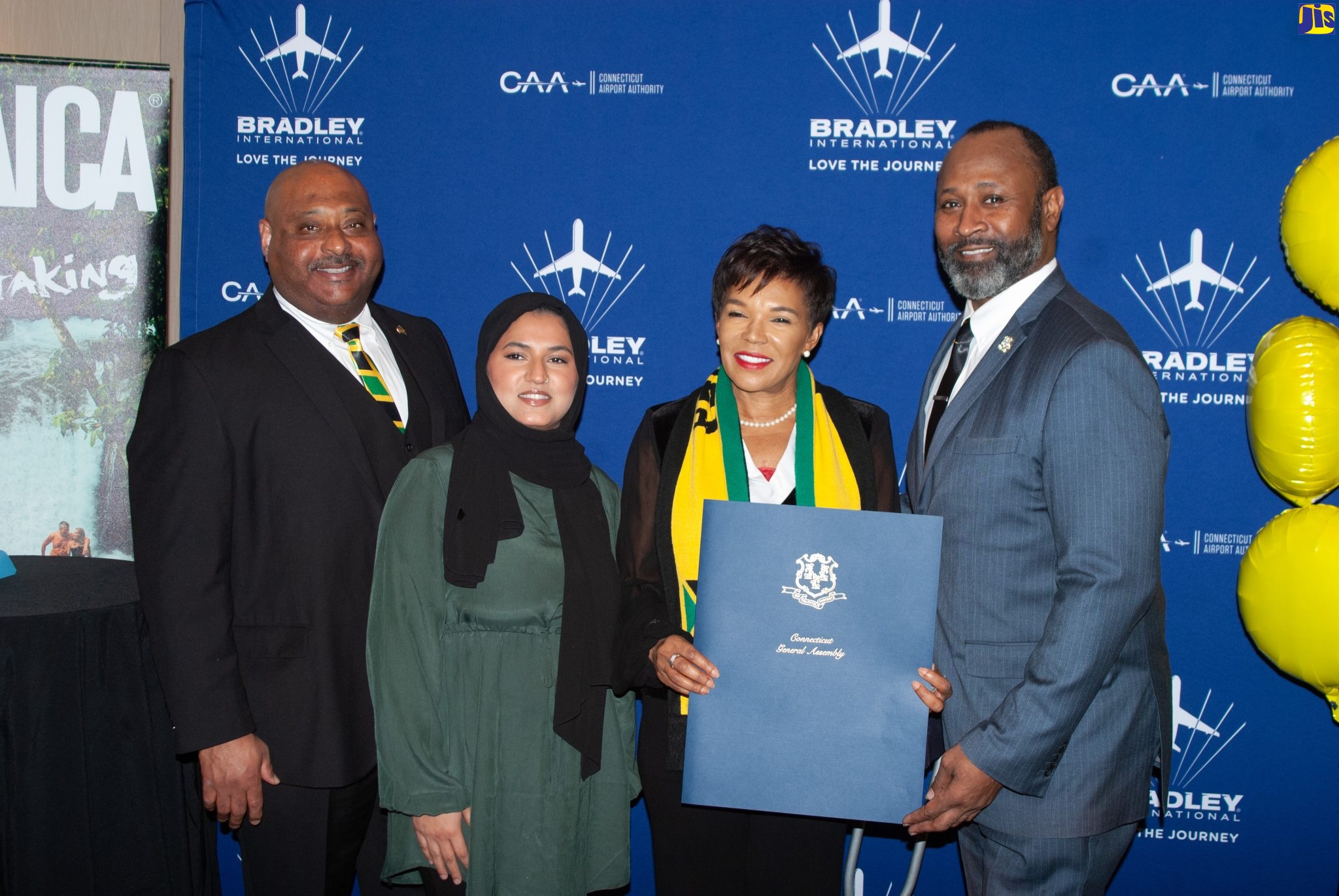 Jamaica’s Ambassador to the United States (US), Her Excellency Audrey Marks (second right),  receives the Governor’s proclamation declaring December 15 ‘Jamaica Day’ in the State of Connecticut, from State Representative, Bobby Gibson (right), representing Governor Ned Lamont. Sharing the moment (from left) are Head of the Caribbean Trade Council in Connecticut, Andrew Lawrence, and State Representative, Marym Khan. The presentation was made at a function to launch Spirit Airlines’ new nonstop service to Montego Bay, Jamaica from the Bradley International Airport (BDL) in Windsor Locks just outside of Hartford, Connecticut, on Thursday (December 15).