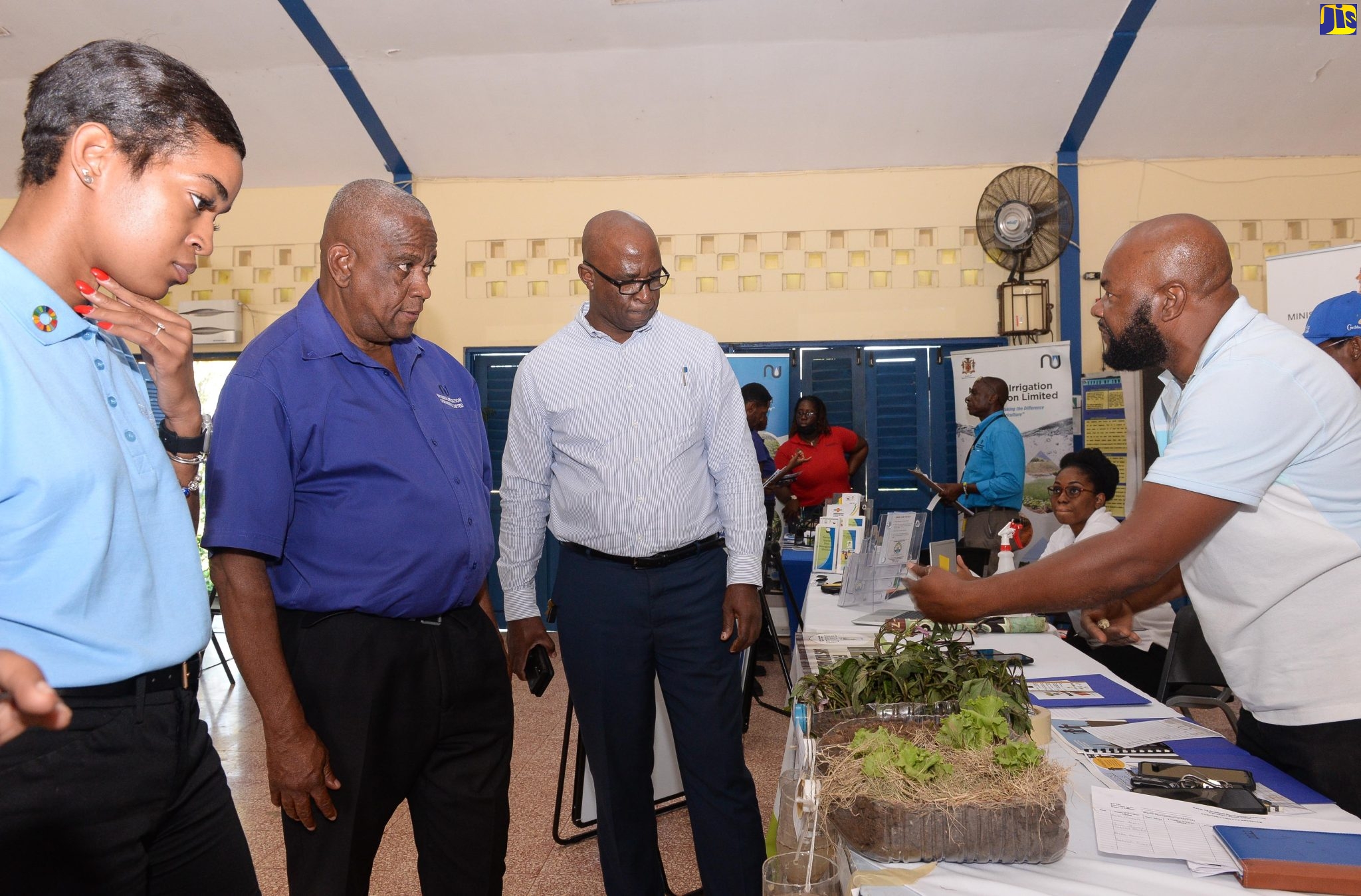 State Minister in the Ministry of Agriculture and Fisheries, Hon. Franklyn Witter (second left), is shown a display at the Rural Agricultural Development Authority’s (RADA) booth by RADA Land Management Officer, Gabbidon Lebert (right), during a World Soil Day event at the Ebony Park HEART Academy in Clarendon, on Wednesday (December 5). Others (from left) are Programme Management and Monitoring Specialist, Food and Agriculture Organization (FAO), Jhannel Tomlinson, and Chief Technical Director in the Agriculture Ministry, Orville Palmer. 