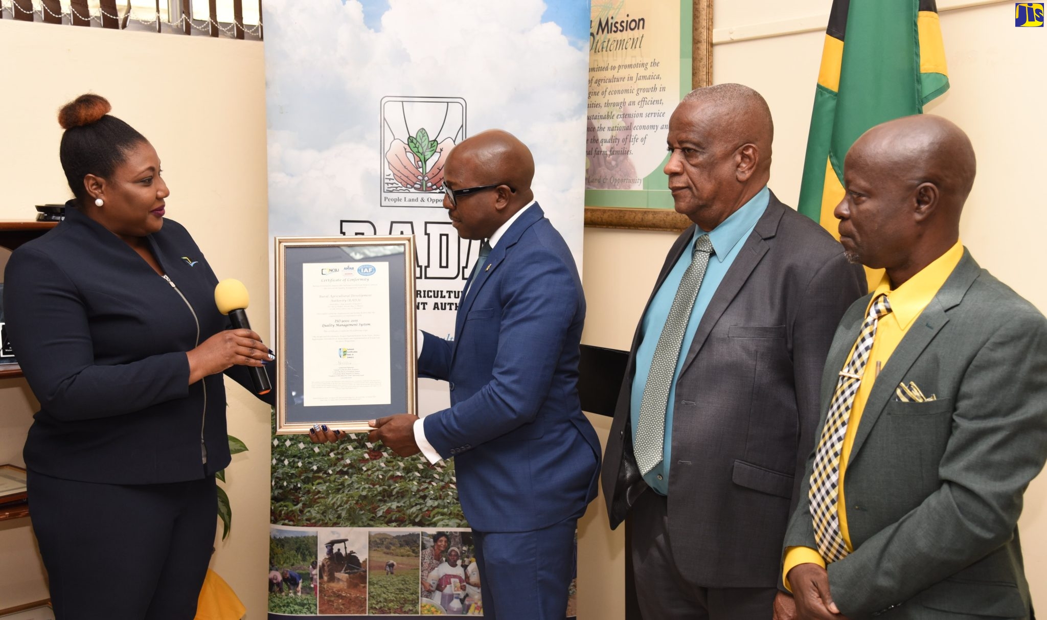 Minister of Agriculture and Fisheries, Hon. Pearnel Charles Jr. (second left) receives the Rural Agricultural Development Authority’s (RADA)  ISO 9001:2015 certificate during a hand over ceremony at RADA’s head office in Kingston on December 13. Making the presentation is Manager, National Certification Body of Jamaica (NCBJ), Navenia Ford (left). Sharing the moment are State Minister in the Ministry of Agriculture and Fisheries, Hon. Franklin Witter (second right) and RADA’s Acting Chief Executive Officer (CEO), Winston Simpson. 
 
