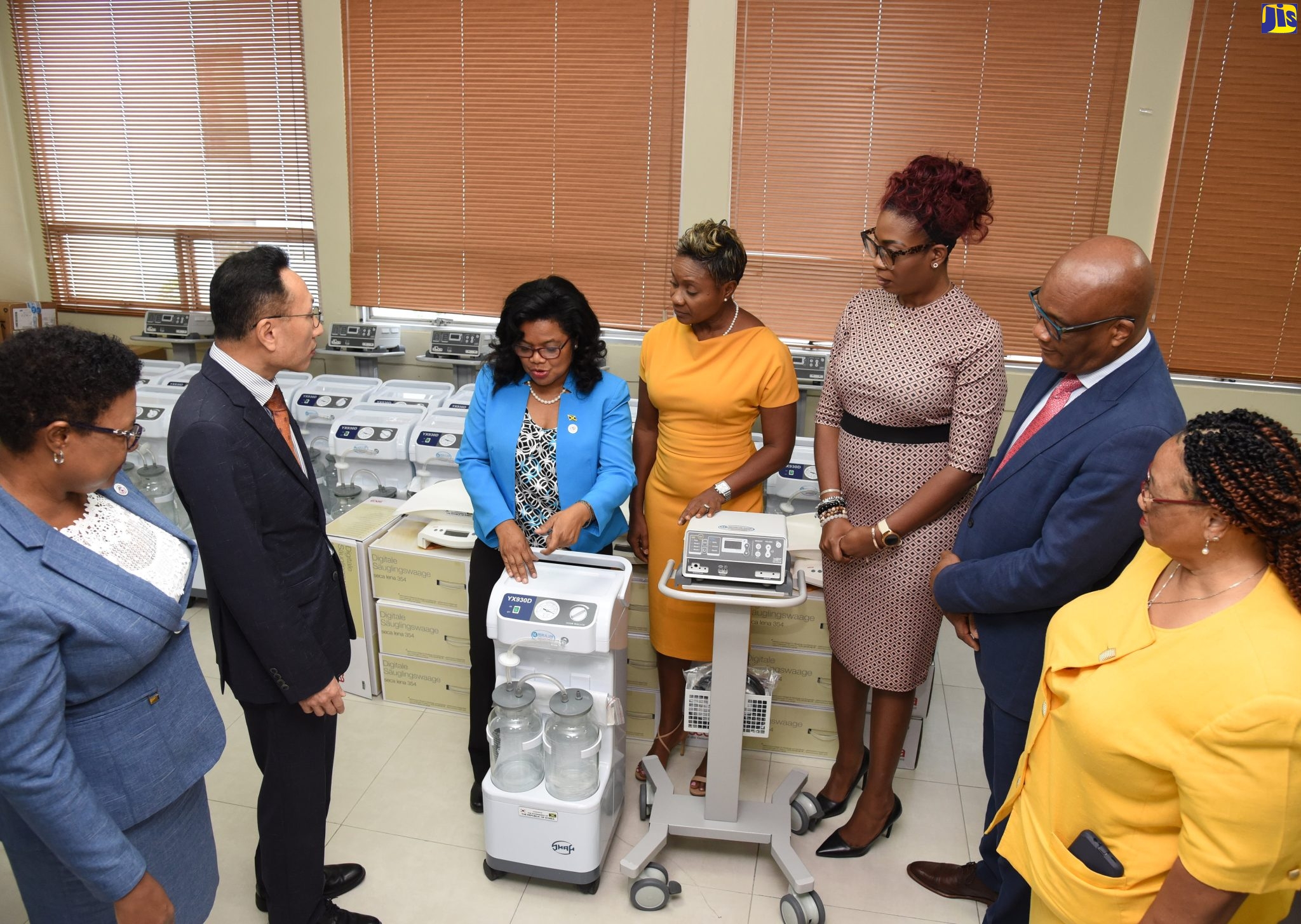 State Minister in the Ministry of Foreign Affairs and Foreign Trade, Senator the Hon. Leslie Campbell (second right); State Minister in the Ministry of Health and Wellness, Hon. Juliet Cuthbert-Flynn (centre) and Chargé d’Affaires, Embassy of the Republic of Korea in Jamaica, Baejin Lim (left) observe as Senior Medical Officer at the Bustamante Hospital for Children, Dr. Michelle-Ann Richards-Dawson (third left) points out features on an anaesthetic machine. Occasion was the handover of medical supplies and equipment donated by the Government of the Republic of Korea at the Ministry of Health and Wellness in Kingston on Tuesday (December 6). Looking on (from left) are Chief Nursing Officer in the Ministry, Patricia Ingram-Martin; Acting Chief Medical Officer, Dr. Simone Spence and Regional Technical Director, South East Regional Health Authority (SERHA), Dr. Sandra Chambers.