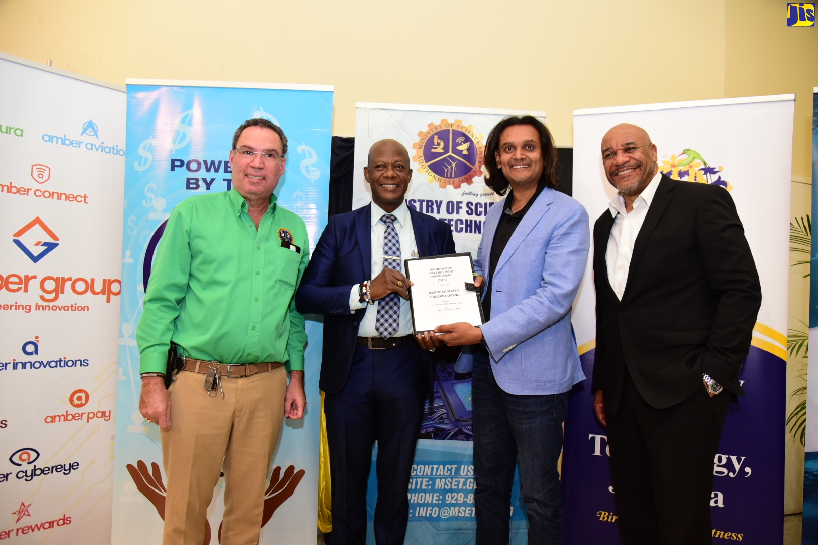 Minister of Science, Energy and Technology, Hon. Daryl Vaz (left), participates in the ceremony for the signing of a Memorandum of Understanding (MOU) for the Technology Advancement Programme (TAP) III), held on Thursday (January 12) at the University of Technology (UTech) campus in St. Andrew.  From second left, Chief Executive Officer (CEO), Universal Service Fund (USF), Daniel Dawes and CEO, Amber Group Limited, Dushyant Savadia, display the signed MOU, while Managing Director, Amber Group Limited, Michael McNaughton, shares the moment.