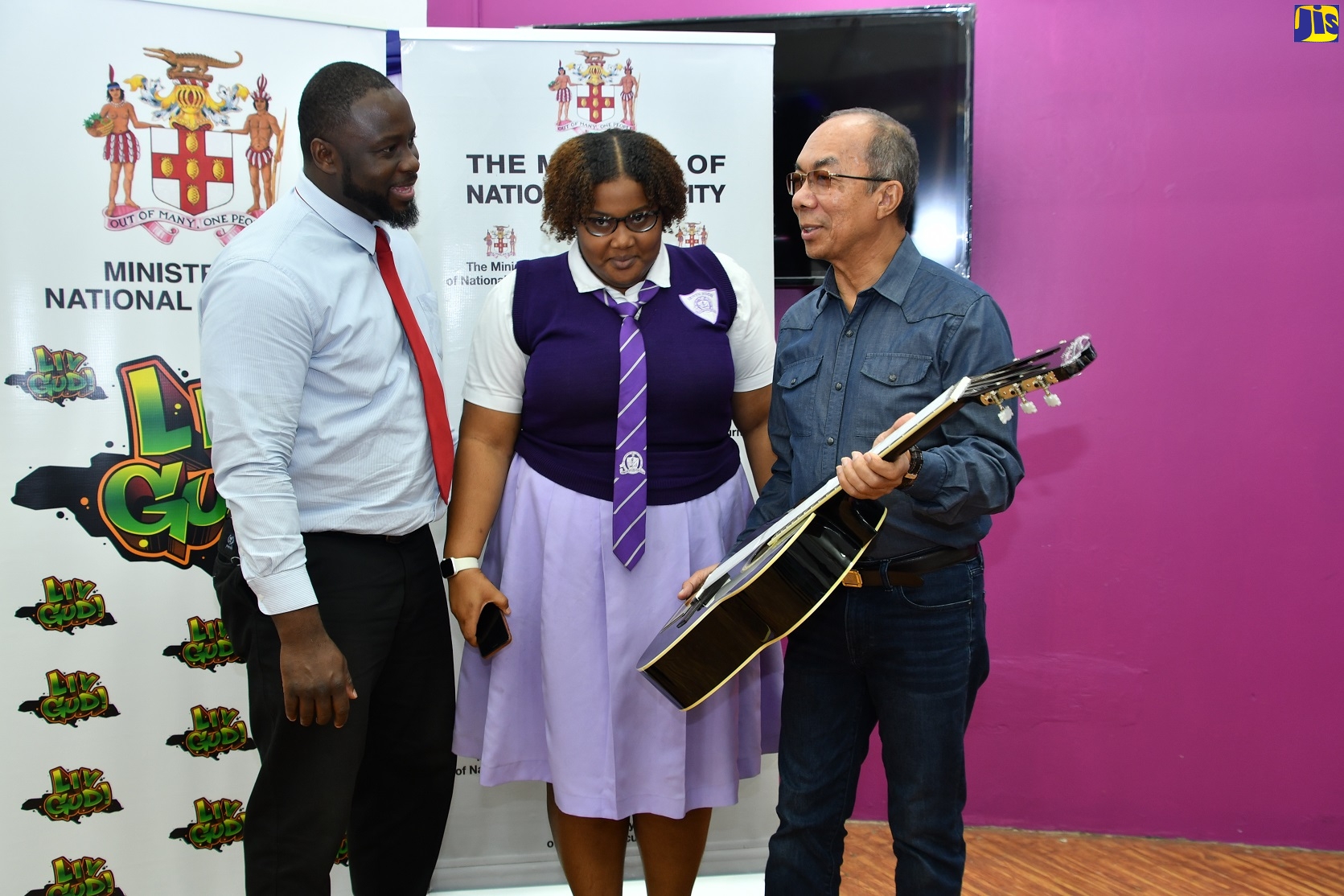 Deputy Prime Minister and Minister of National Security, Hon. Dr. Horace Chang (right), displays a guitar donated to Irwin High School in St. James under the Ministry’s ‘Liv Gud’ Music, Sports, and Technology programme. The guitar along with a keyboard were handed over during a ceremony at the institution on Friday (January 27). Sharing the moment (from left) are music teacher and cultural agent at the institution, Keron Thompson (left), and Student Council President, Jamela Shukurah. 