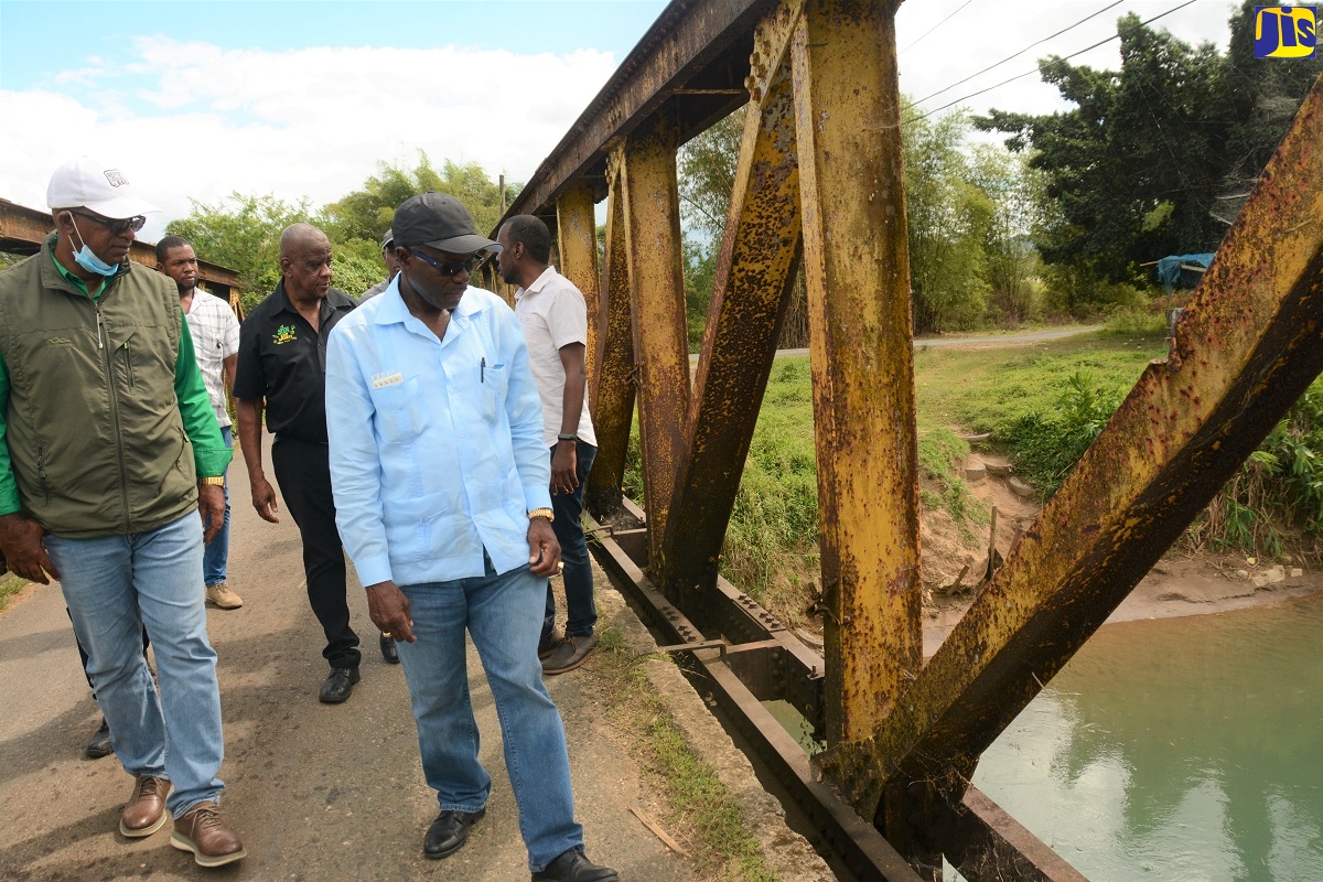 Minister without Portfolio in the Ministry of Economic Growth and Job Creation (MEGJC), with responsibility for works, Hon Everald Warmington (right) and Member of Parliament (MP) for St Elizabeth North Eastern, Delroy Slowley (left), examine Wilson Bridge in Aberdeen, during a tour of the constituency on January 25. At third left is MP for St. Elizabeth Southeast and State Minister in the Ministry Of Agriculture and Fisheries, Hon. Franklin Witter