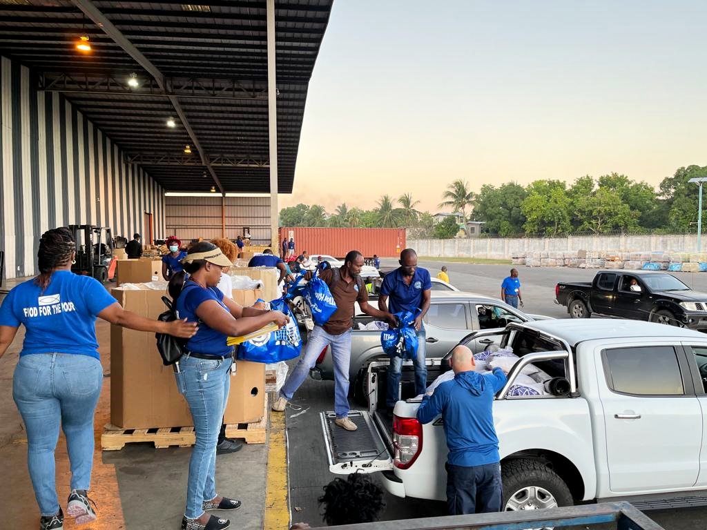 Members of staff at the charity organisation, Food For the Poor (FFP), prepare food packages at their Spanish Town, St. Catherine corporate offices,  for distribution during the holiday season.