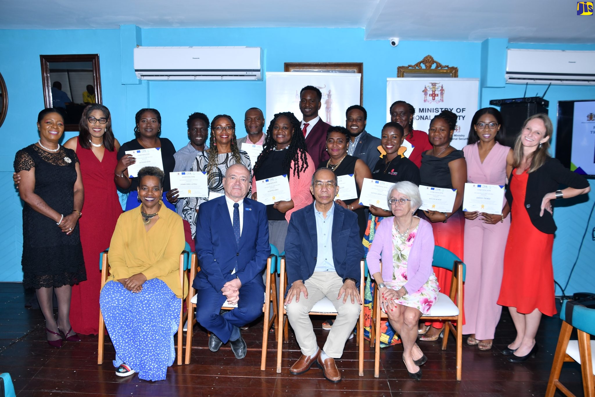 Deputy Prime Minister and Minister of National Security, Hon. Dr. Horace Chang (second right, seated), and Head of Cooperation, Delegation of the European Union to Jamaica, Aniceto Rodriguez Ruiz (second left, seated), along with Executive Director, Citizen Security Secretariat, Dianne McIntosh (left, seated), and Chair, Violence Prevention Alliance, Professor Elizabeth Ward (right, seated), are joined by the initial participants in the psychological first aid responders training programme, during their graduation ceremony at the S Hotel in Montego Bay on Friday (January 27).