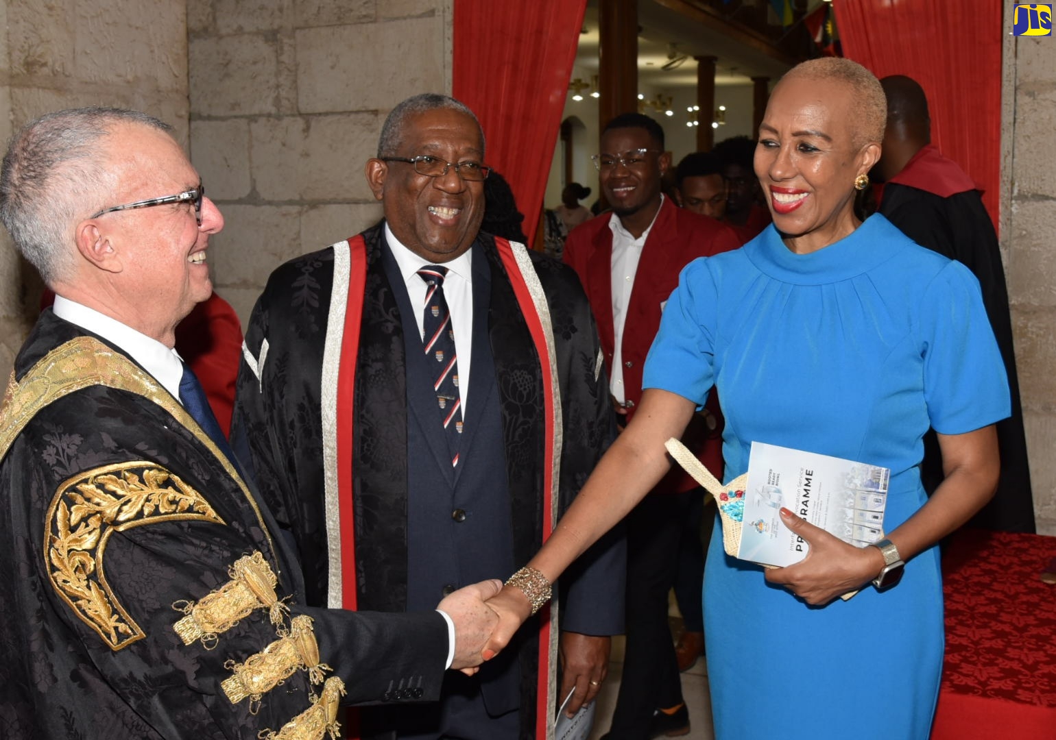 Minister of Education and Youth, Hon. Fayval Williams (right), shakes hands with Chancellor, University of the West Indies (UWI), Robert Bermudez (left), after the Interfaith Convocation Service held at the University Chapel,  St. Andrew, on Sunday (December 8). Looking on is Pro-Vice Chancellor and Principal, UWI, Professor Dale Webber.