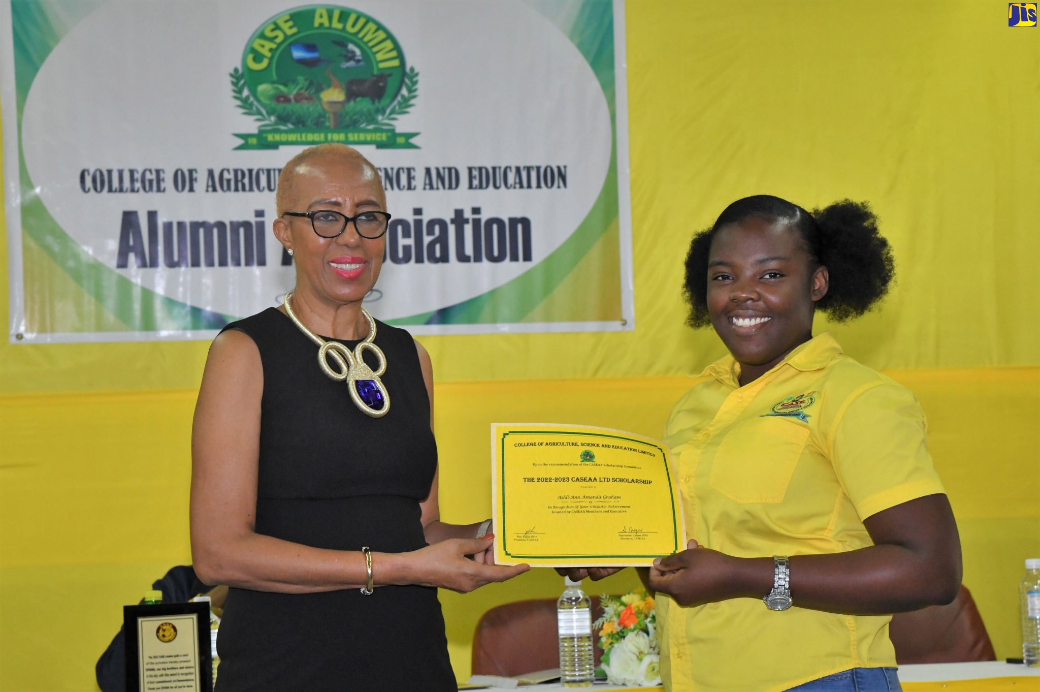 Minister of Education and Youth, Hon. Fayval Williams (left), presents a scholarship certificate to College of Agriculture, Science and Education (CASE) student, Ashli-Ann Graham, during the institution’s Founders’ Weekend Celebration on Saturday (January 28). Minister Williams was the keynote speaker at the event, which was held at the institution’s campus in Portland under the theme: ‘Celebrating our Legacy, Creating Visions of Excellence’.