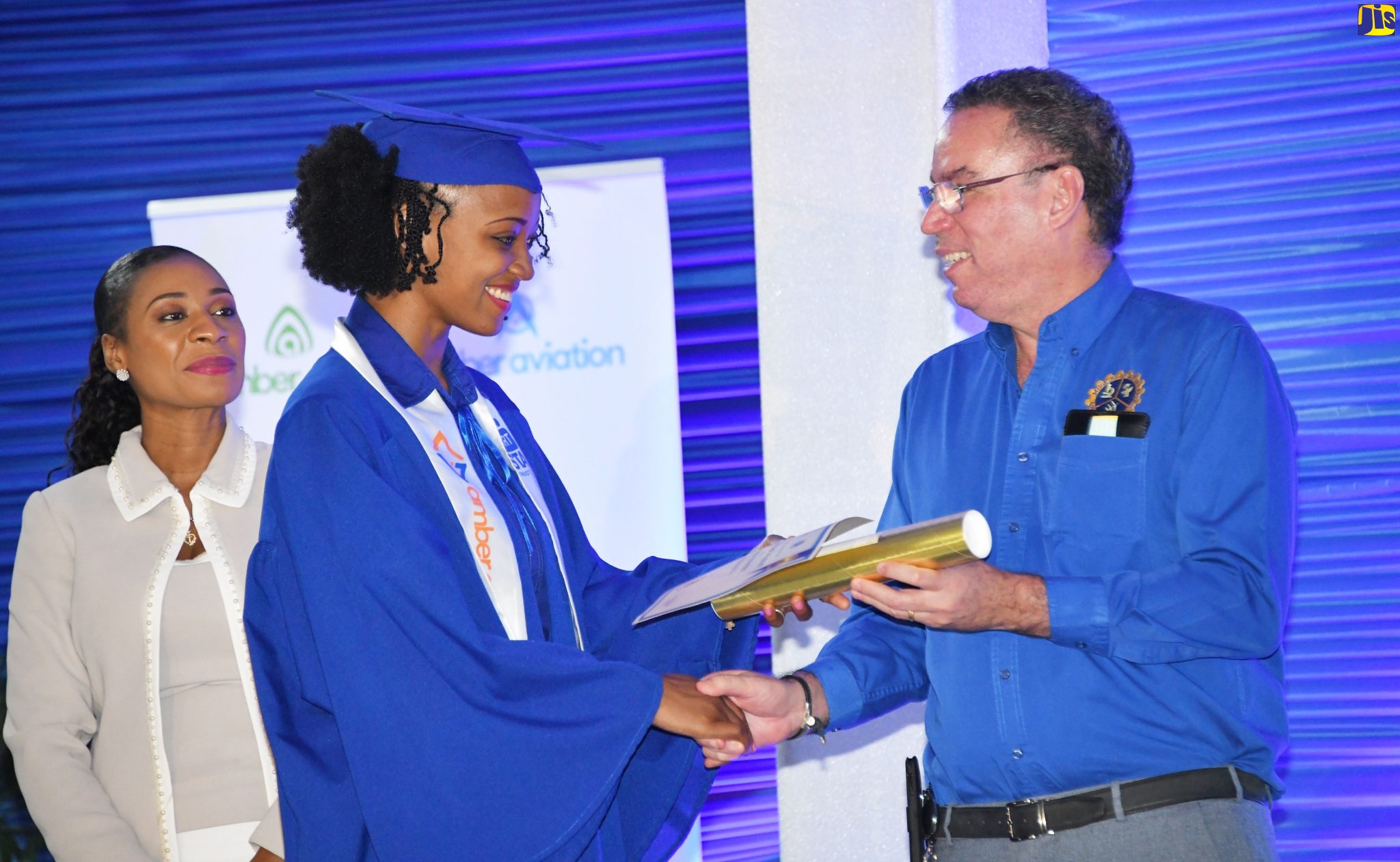 Minister of Science, Energy and Technology, Hon. Daryl Vaz (right), presents Anita Baker with her National Council on Technical and Vocational Education and Training (NCTVET) certificate at the Amber HEART Academy graduation ceremony held at the HEART/NSTA Trust Stony Hill Campus in St. Andrew on Tuesday (January 11).