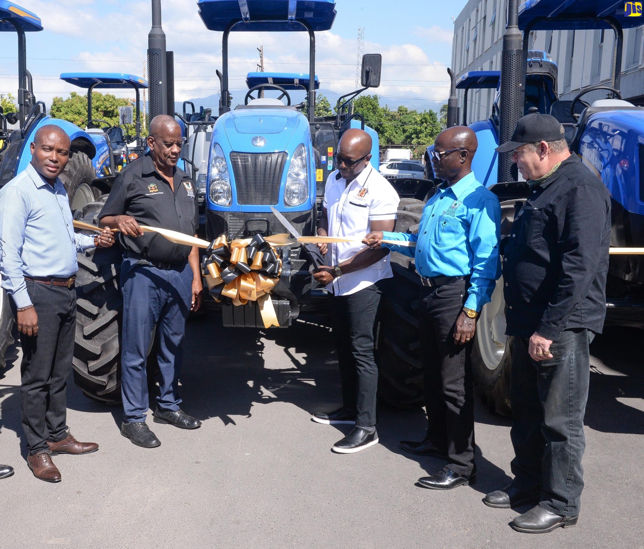 Minister of Agriculture and Fisheries, Hon. Pearnel Charles Jr (centre) and State Minister, Hon. Franklin Witter (second left), lead a ribbon-cutting exercise during Tuesday’s (January 17) handover of six farm tractors, valued at approximately $49.7 million, to the Rural Agricultural Development Authority (RADA). Joining them are (from left) Chief Technical Director in the Ministry, Courtney Cole; Acting CEO, RADA, Winston Simpson and Vice Chairman, RADA Board of Directors, Richard King. 