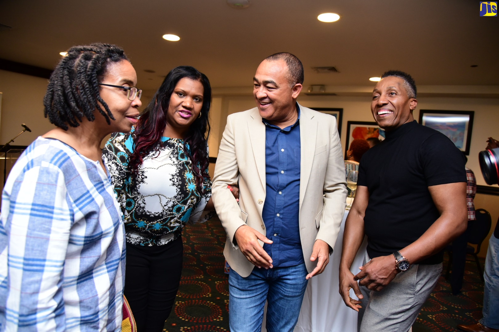 Minister of Health and Wellness, Dr. the Hon. Christopher Tufton (second right), engages in light conversation with medical and health professionals, who are among three teams visiting the island to conduct surgeries over the next two weeks. Occasion was a welcome reception held at The Jamaica Pegasus hotel in New Kingston on Sunday (January 15). From left are Anaesthesiologist, Dr. Carlene Broderick; Registered Nurse, Heather Tucker; and Perfusionist, David Fallon. 