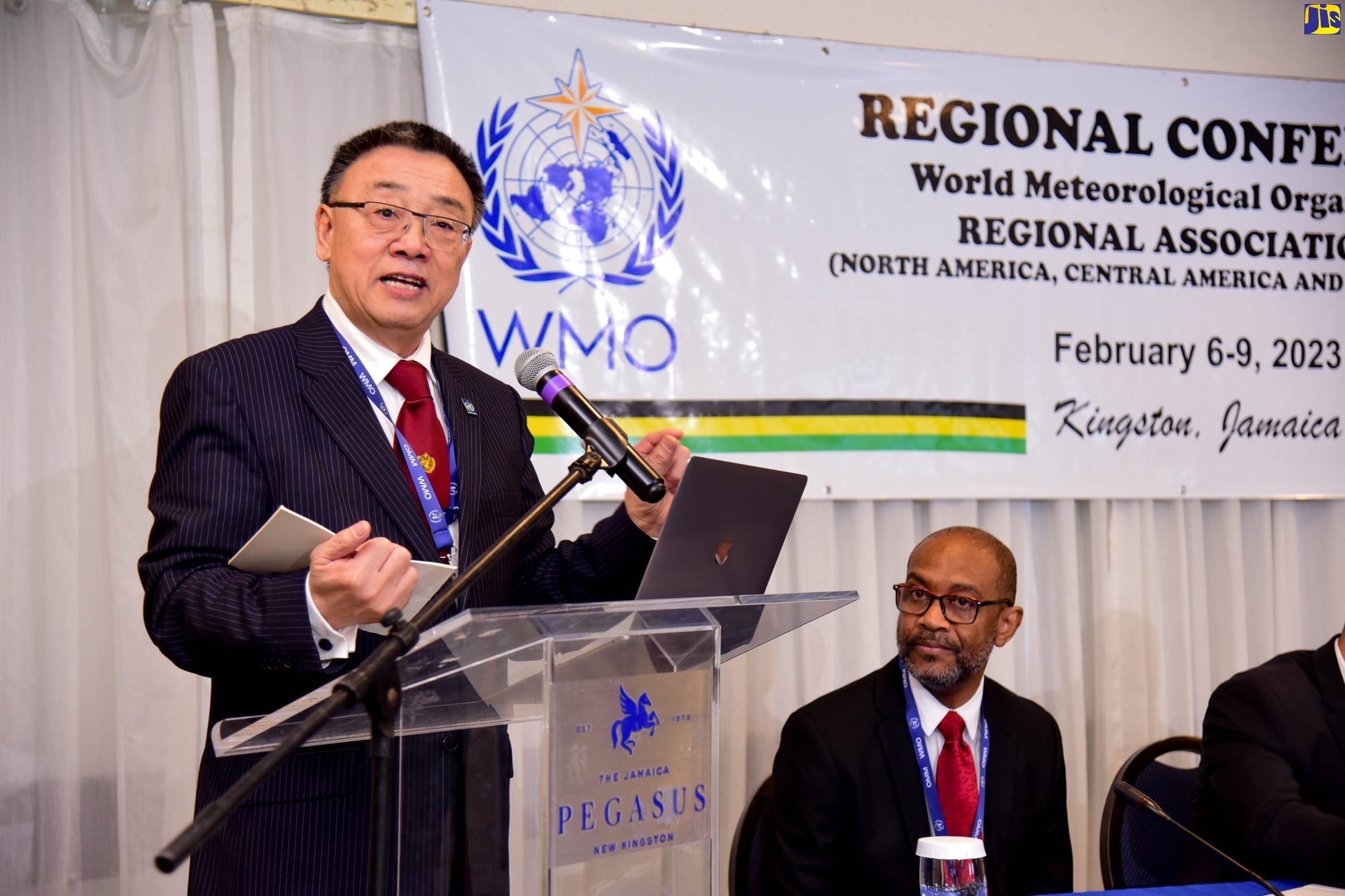 Assistant Secretary-General of the World Meteorological Organization (WMO), Dr. Wenjian Zhang, addresses the February 6 opening ceremony of the four-day WMO Regional Conference (Regional Association IV), held at The Jamaica Pegasus hotel. Listening is WMO President for Regional Association IV and Director of the Meteorological Service of Jamaica, Evan Thompson.