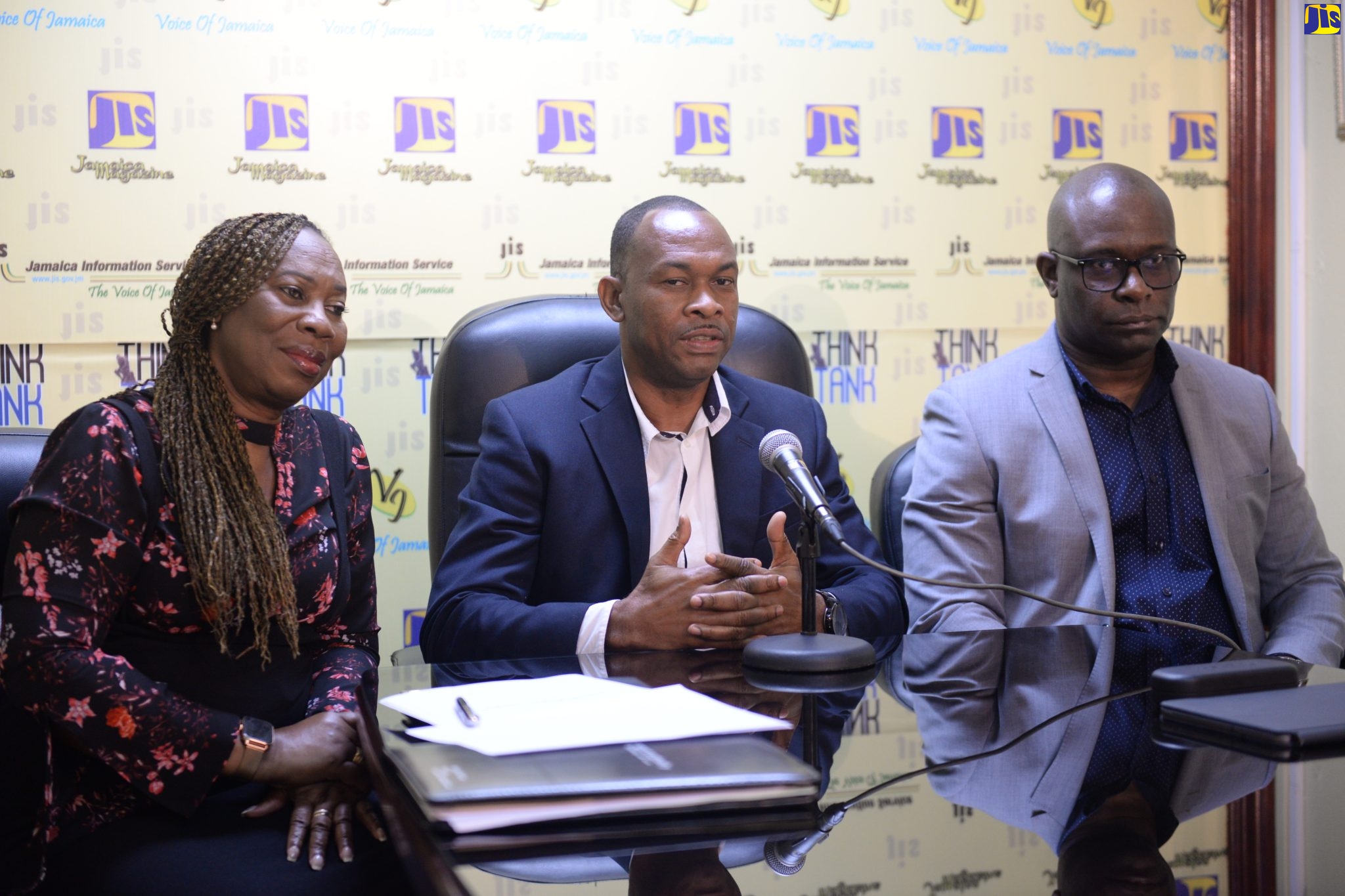 Managing Director of the Transport Authority (TA), Ralston Smith (centre), addresses a JIS Think Tank on the online application process for the 2023/2024 licensing period. He is flanked by  Corporate Communications Manager, Merdina Callum (left(, and General Manager, Management Information Systems, Vernon Walters. 

