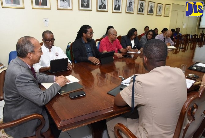 Vice Chairman of the National Road Safety Council, Dr. Lucien Jones (second left), at a meeting with stakeholders on the Traffic Ticket Management System in 2019, which was chaired by Minister of National Security, Hon. Dr. Horace Chang (left).