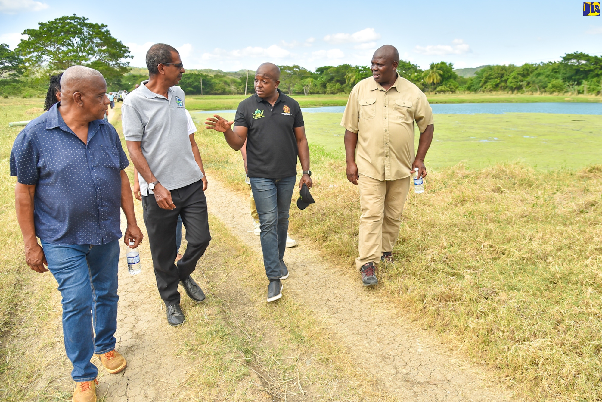 Minister of Agriculture and Fisheries, Hon. Pearnel Charles Jr. (second right), in discussion with Chief Executive Officer of the National Fisheries Authority (NFA), Dr. Gavin Bellamy (second left), during a tour of McLish Fish Farm in St. Catherine on Wednesday (February 1). Accompanying them are (from left) State Minister in the Agriculture Ministry, Hon. Franklin Witter and farm proprietor, Stephen McLish.