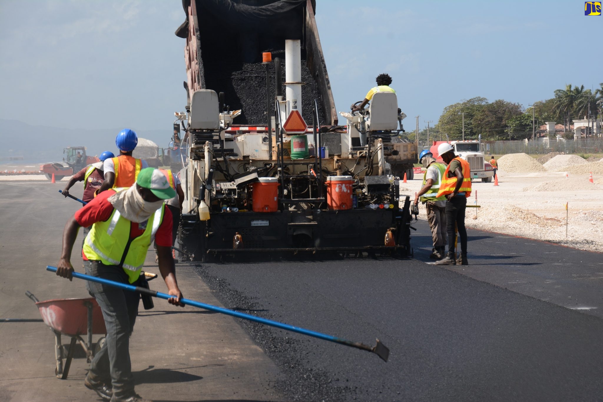 Workers carrying out paving under the US$34-million runway extension at the Sangster International Airport (SIA) in St. James. 