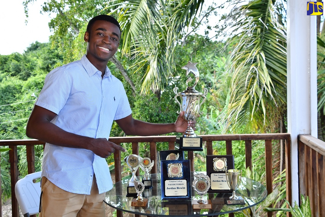 Eighteen-year-old Campion College student, Jordan Hewitt, showcases his collection of awards at his home in Marvins Park, St. Ann.