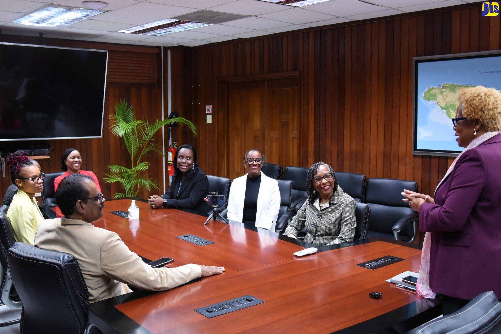 Permanent Secretary (Acting) in the Ministry of Education and Youth (MOEY), Maureen Dwyer (standing) greets the finalists of the LASCO/MOEY Principal and Teacher of the Year Award, as well as Senior Executives of the LASCO Group, during a courtesy call held at the Ministry in Kingston on Wednesday, February 1.