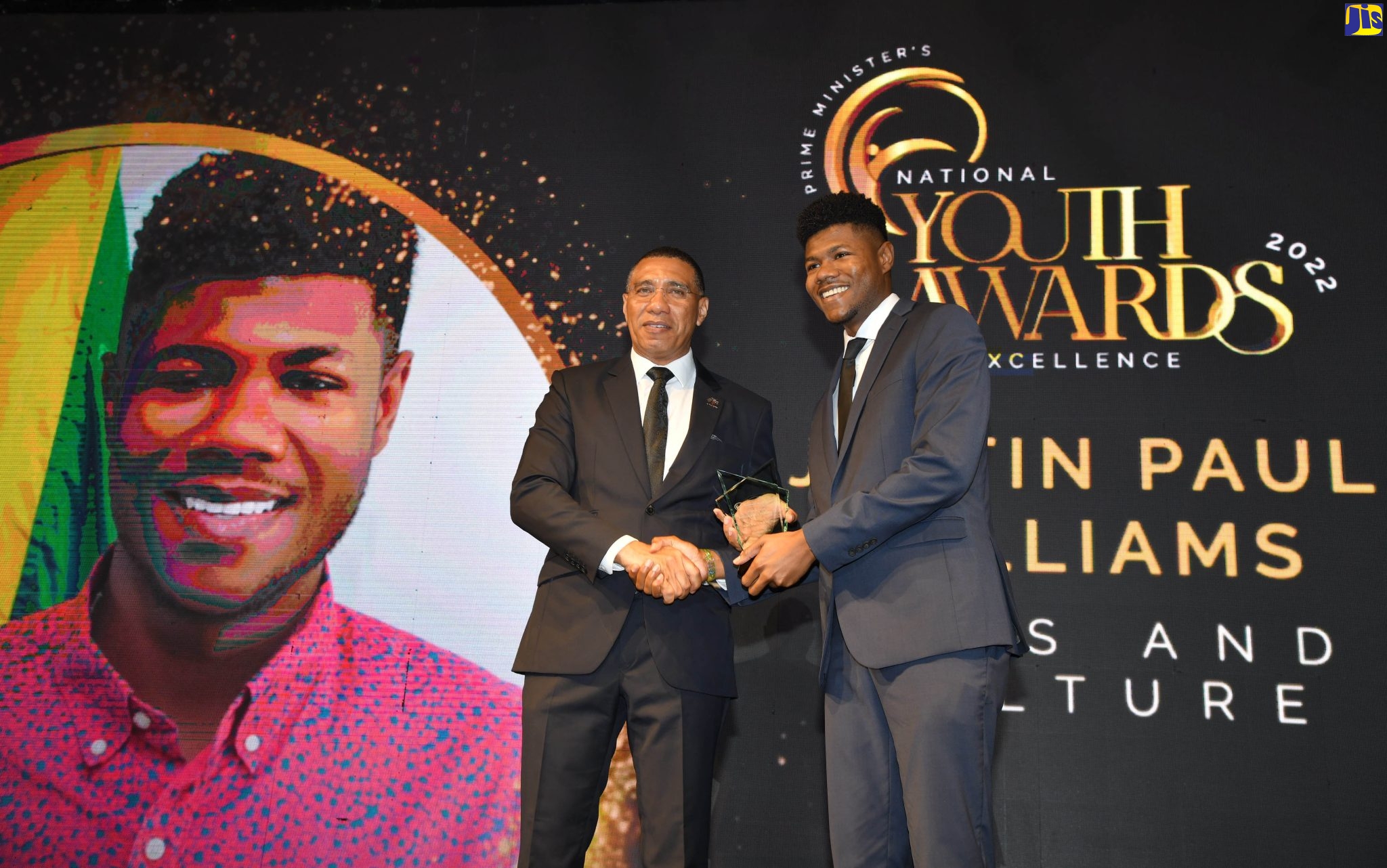 Prime Minister, the Most Hon. Andrew Holness (left), presents the award in the category of arts and culture to Justin Paul Williams during the Prime Minister’s Youth Awards for Excellence 2022, which was held Saturday evening (Feb.4), on the lawns of Jamaica House.