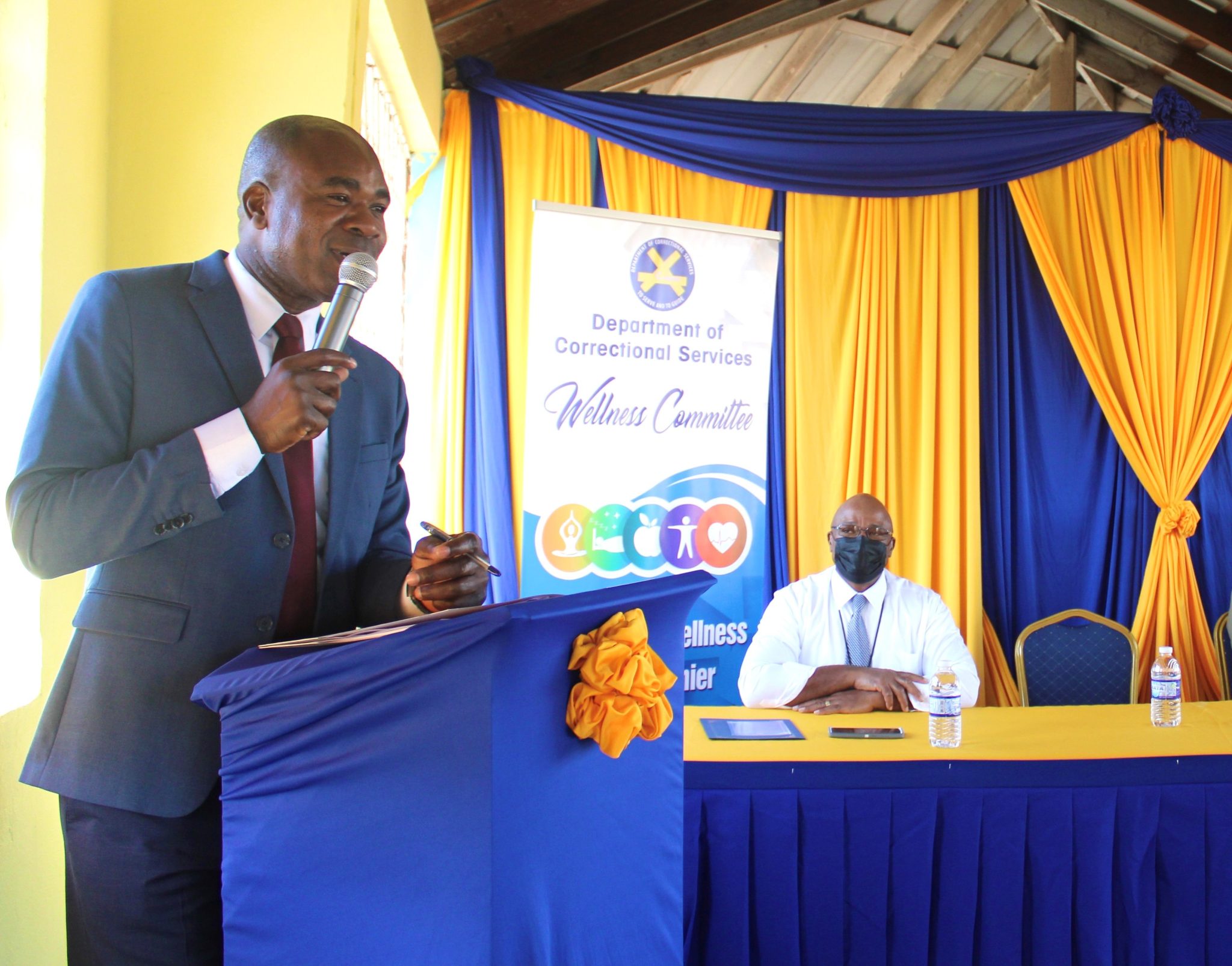 Minister of State in the Ministry of National Security, Hon. Zavia Mayne, addresses the recent launch of the Department of Correctional Service’s (DCS) wellness fairs held at its Spanish Town Sport Club in St. Catherine. Also pictured is Commissioner of Corrections, Lieutenant Colonel (Retired) Gary Rowe.