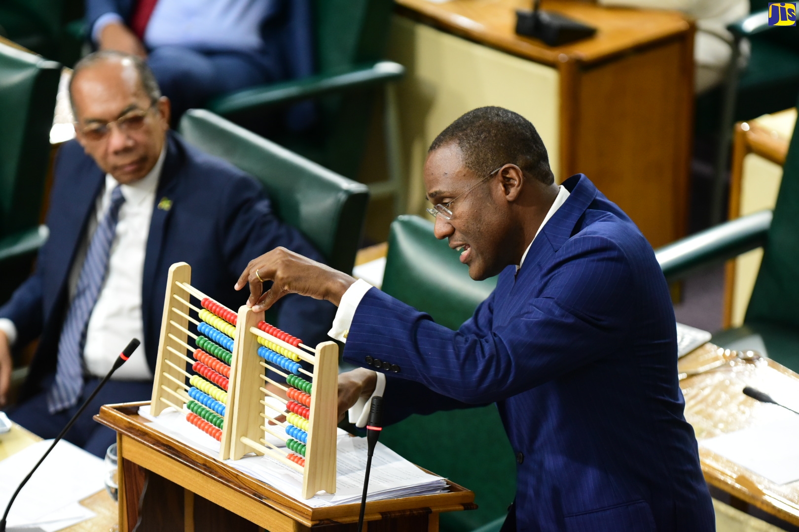 Minister of Finance and the Public Service, Dr. the Hon. Nigel Clarke, uses abacus counting tools as he opened the 2023/24 Budget Debate in the House of Representatives, on Tuesday (March 7).