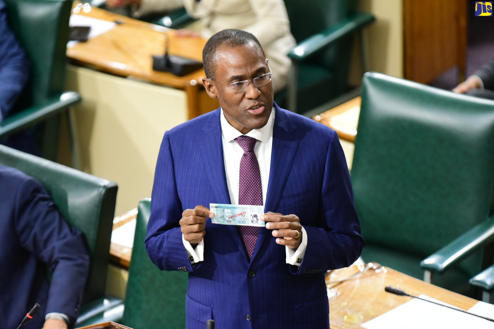 Minister of Finance and the Public Service, Dr. the Hon. Nigel Clarke, displays a specimen of the new $100 Jamaican bank note, as he opened the 2023/24 Budget Debate in the House of Representatives on Tuesday (March 7).