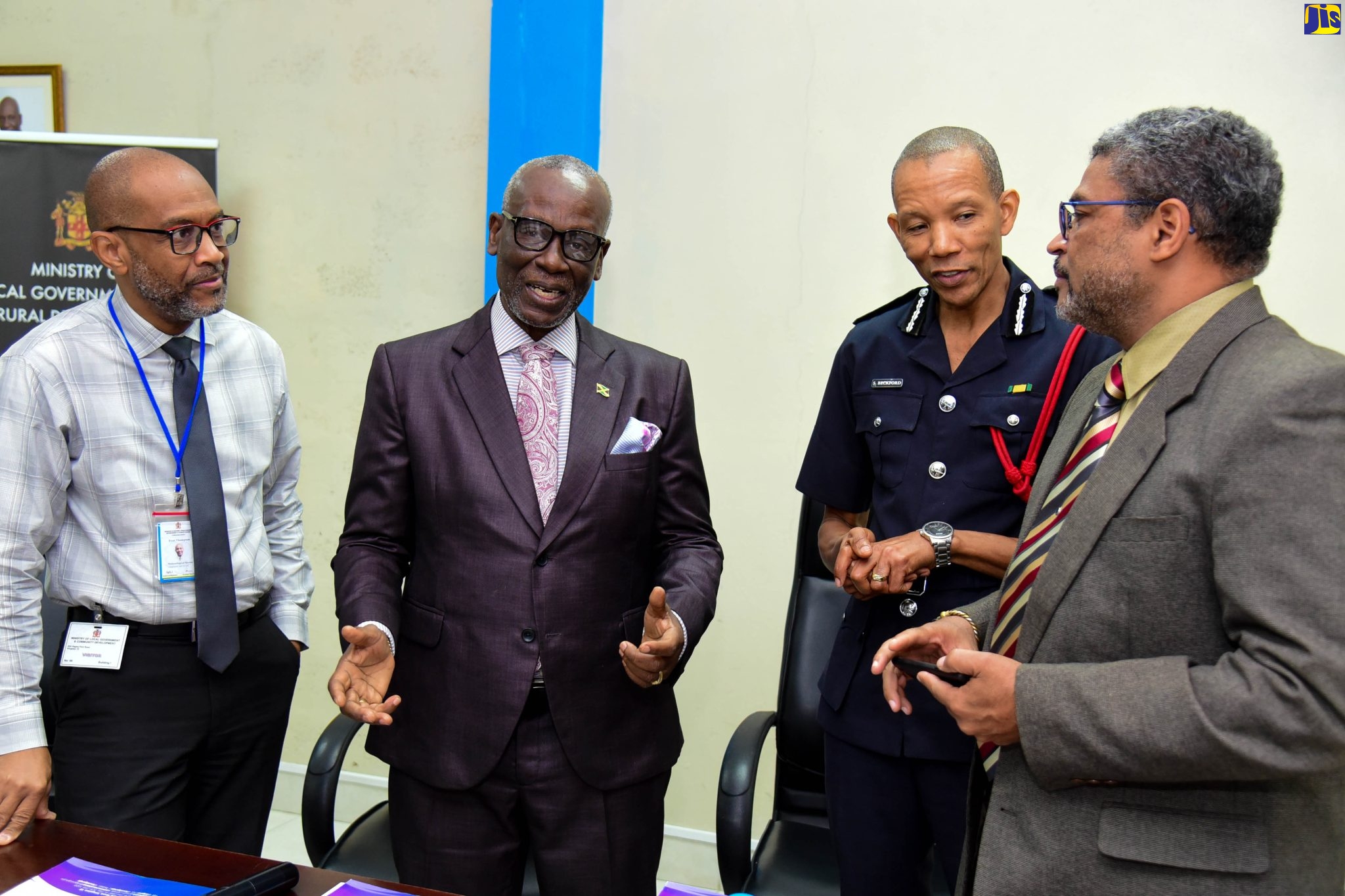 Minister of Local Government and Rural Development, Hon. Desmond McKenzie (second left), converses with (from left) Director, Meteorological Service (MET Office), Evan Thompson; Commissioner of the Jamaica Fire Brigade (JFB) Stewart Beckford and Managing Director, National Water Resource Authority (NRA), Peter Clarke, at a press conference held on Thursday (March 9) at the Ministry in Kingston.