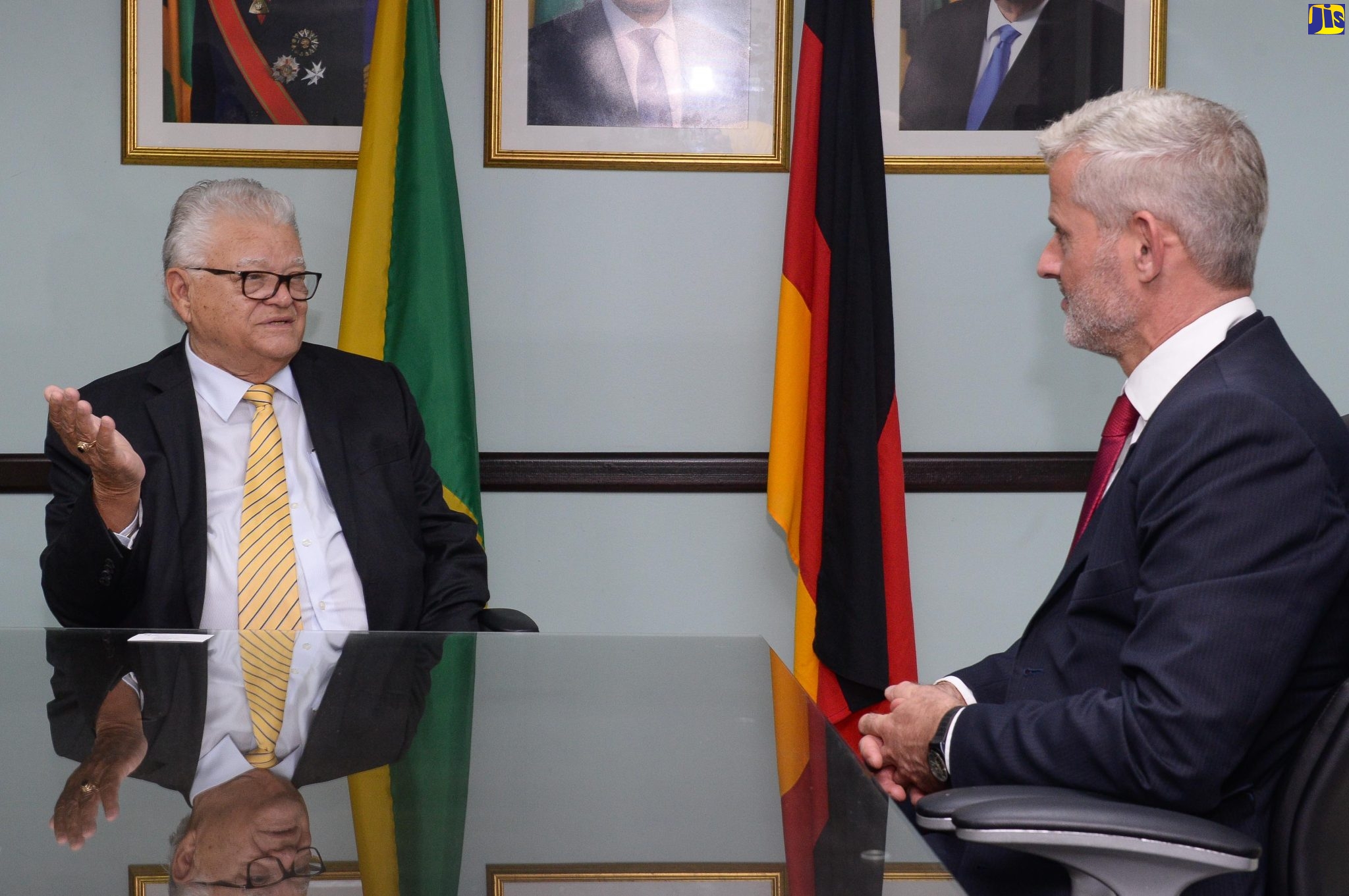 Minister of Labour and Social Security, Hon. Karl Samuda (left), emphasises a point during conversation with Ambassador of the Federal Republic of Germany to Jamaica, His Excellency Jan Hendrik van Thiel, during a courtesy call held at the Ministry’s North Street offices on March 29.
