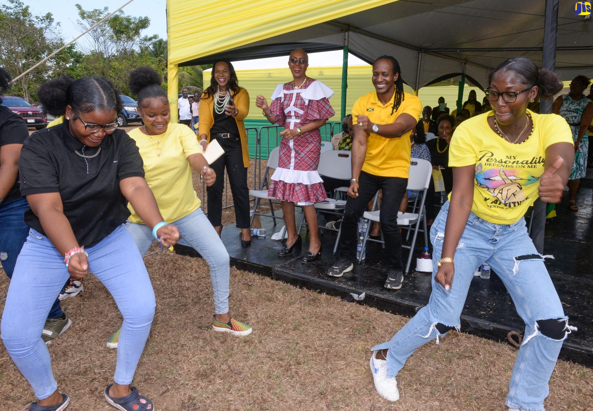 Minister of Education and Youth, Hon, Fayval Williams (background, centre), along with Acting Chief Education Officer, Dr. Kasan Troupe (background, left), and Minister of State in the Ministry of Culture, Gender, Entertainment and Sport, Hon. Alando Terrelonge (background, right), join in a dance during Jamaica Day celebrations held on Friday (March 3), at the St. Catherine-based Dinthill Technical High School in the parish.