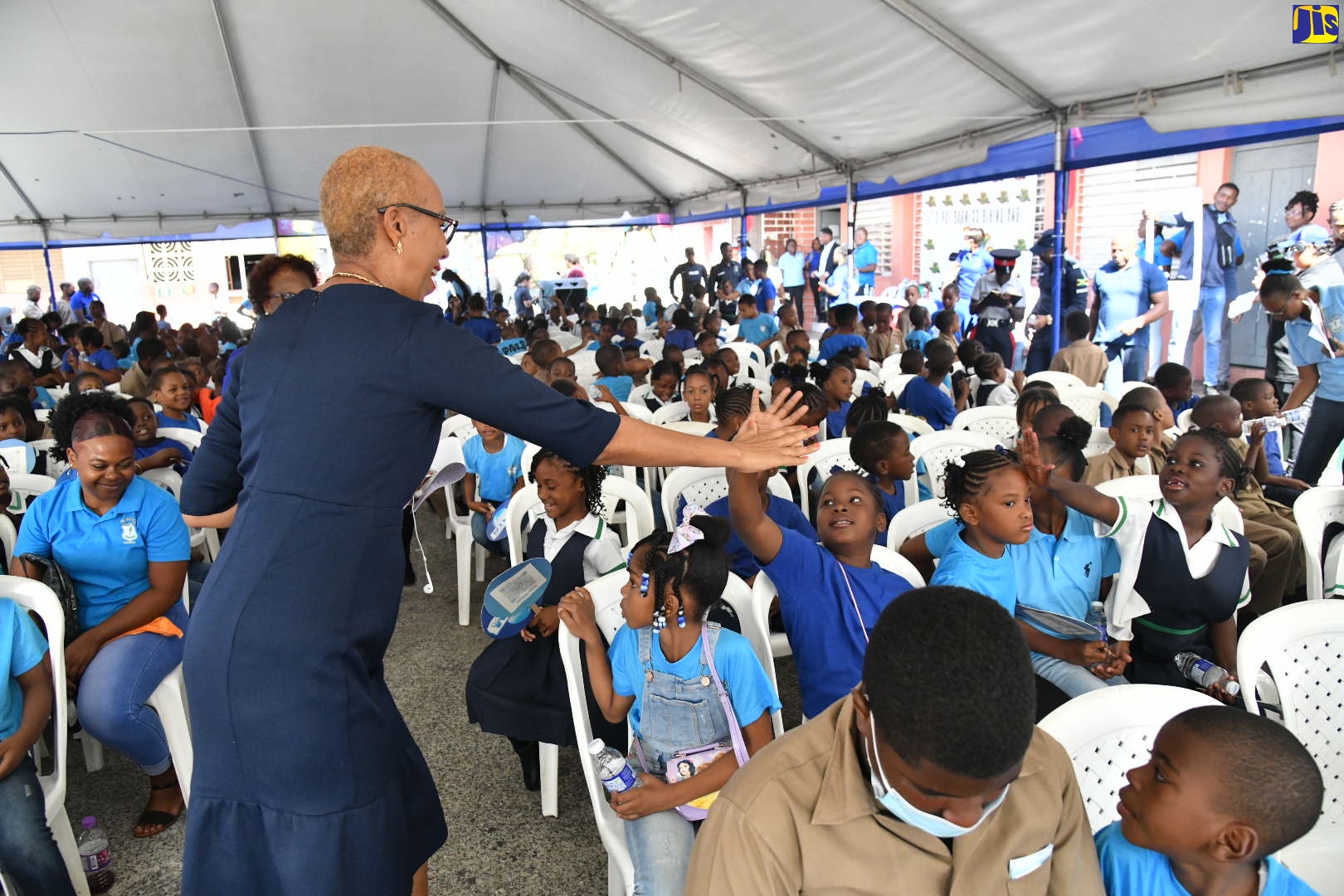 Minister of Education and Youth, Hon. Fayval Williams, high-fives students of the Calabar Infant, Primary and Junior High School in Kingston, during a concert at the institution in observance of Peace Day on Tuesday (March 7).