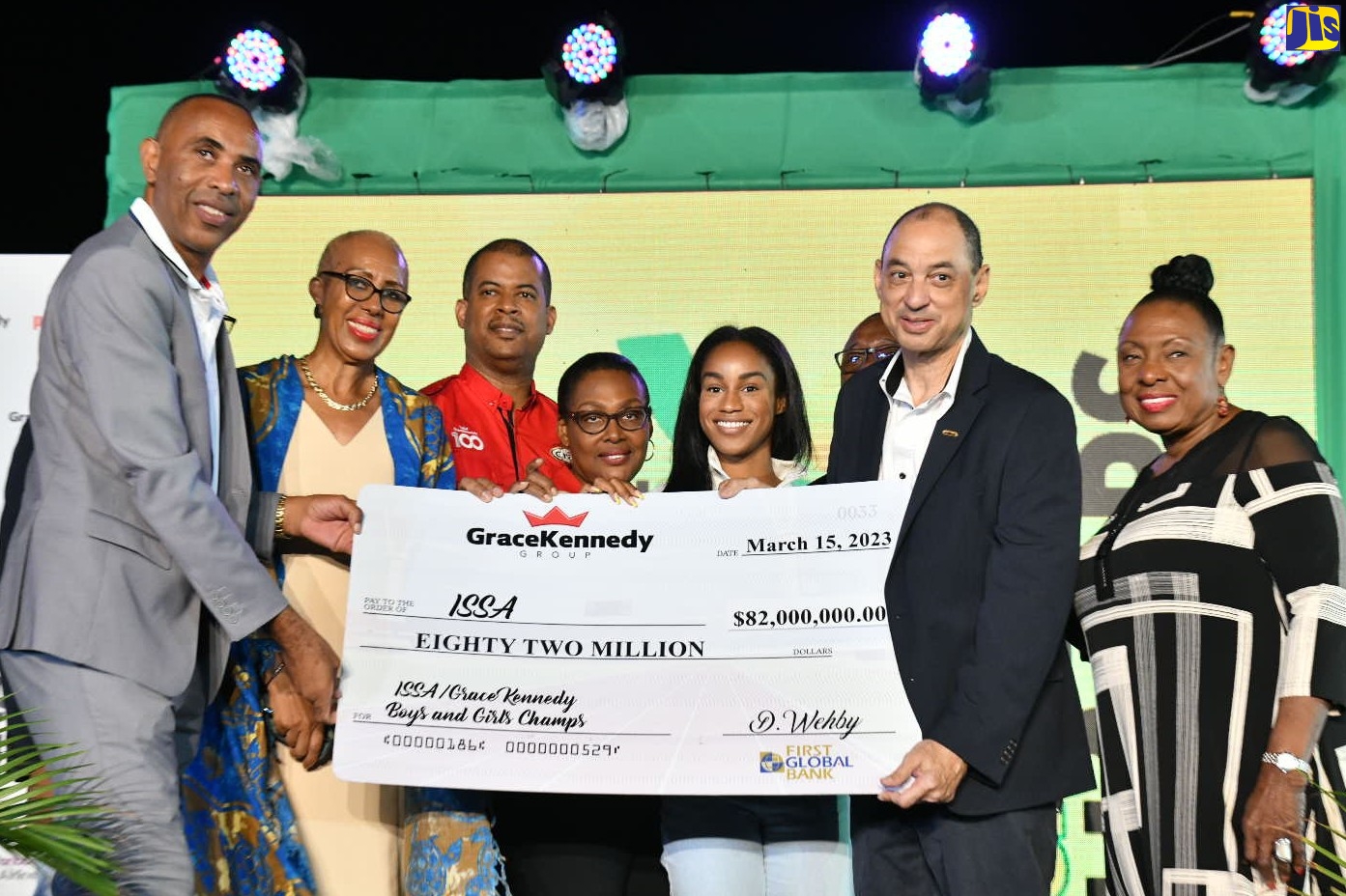 Minister of Culture, Gender, Entertainment and Sport, Hon. Olivia Grange (right), and Minister of Education and Youth, Hon. Fayval Williams (second left), join in the symbolic presentation of a cheque valued at $82 million by GraceKennedy (GK) Group Chief Executive Officer (CEO), Don Wehby (second right) to Inter-Secondary Schools Sports Association (ISSA) President, Keith Wellington (left). The occasion was the media launch of the ISSA/GraceKennedy Boys’ and Girls’ Athletics Championships (Champs) at the National Stadium on Wednesday (March 15). Also sharing in the moment are CEO of GK Foods-Domestic, Frank James (third left); CEO of GK Financial Group, Grace Burnett (fourth left); and Olympic gold medalist, Briana Williams. Champs will be held at the National Stadium from March 28 to April 1.
