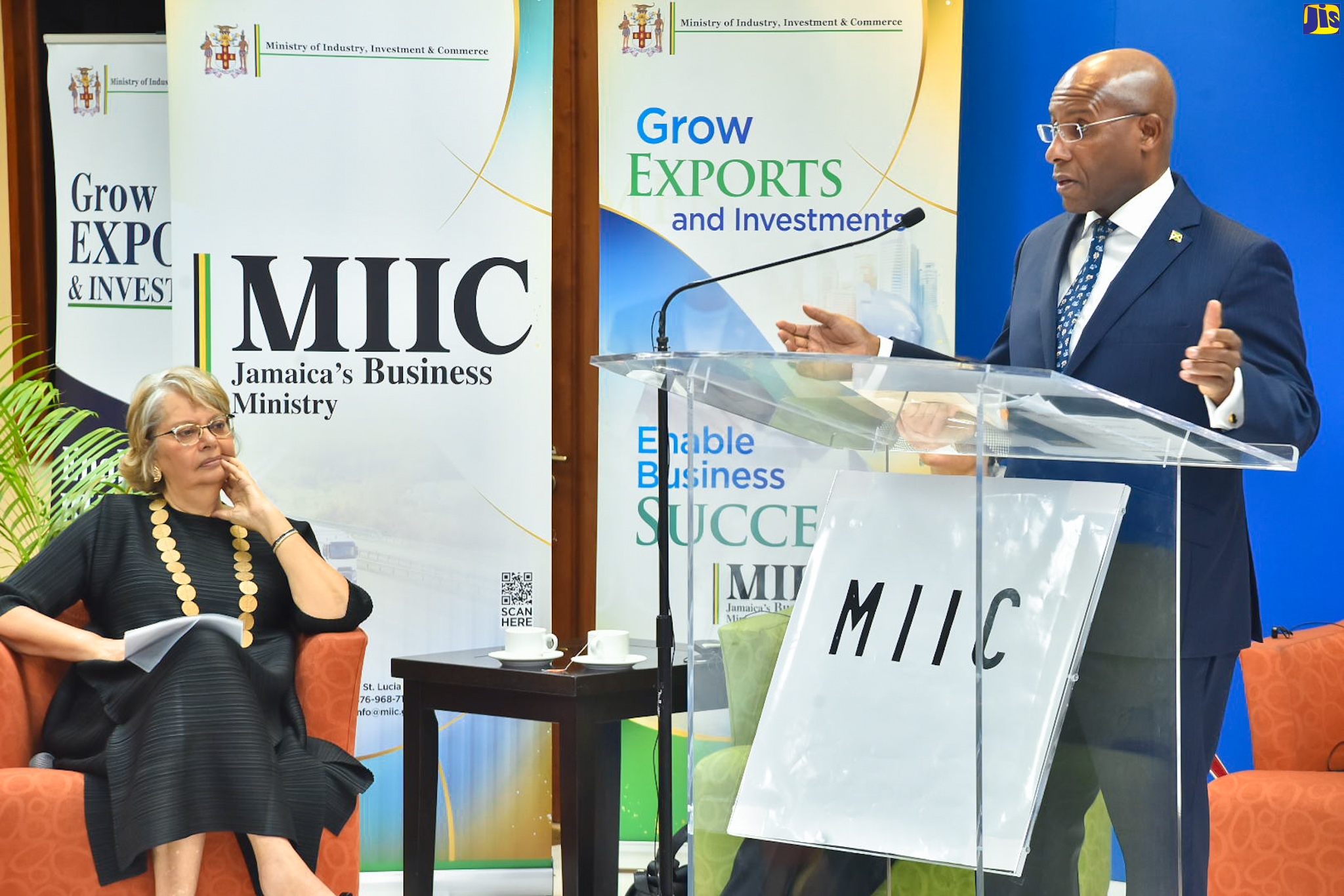 Minister of Industry, Investment and Commerce, Senator the Hon. Aubyn Hill, speaks at a forum on facilitating competitive, safe and secure cross-border trade, held at the Regional Headquarters, University of the West indies, Mona, on March 15. At left is Chairperson, Trade Facilitation Task Force, Patricia Francis.

