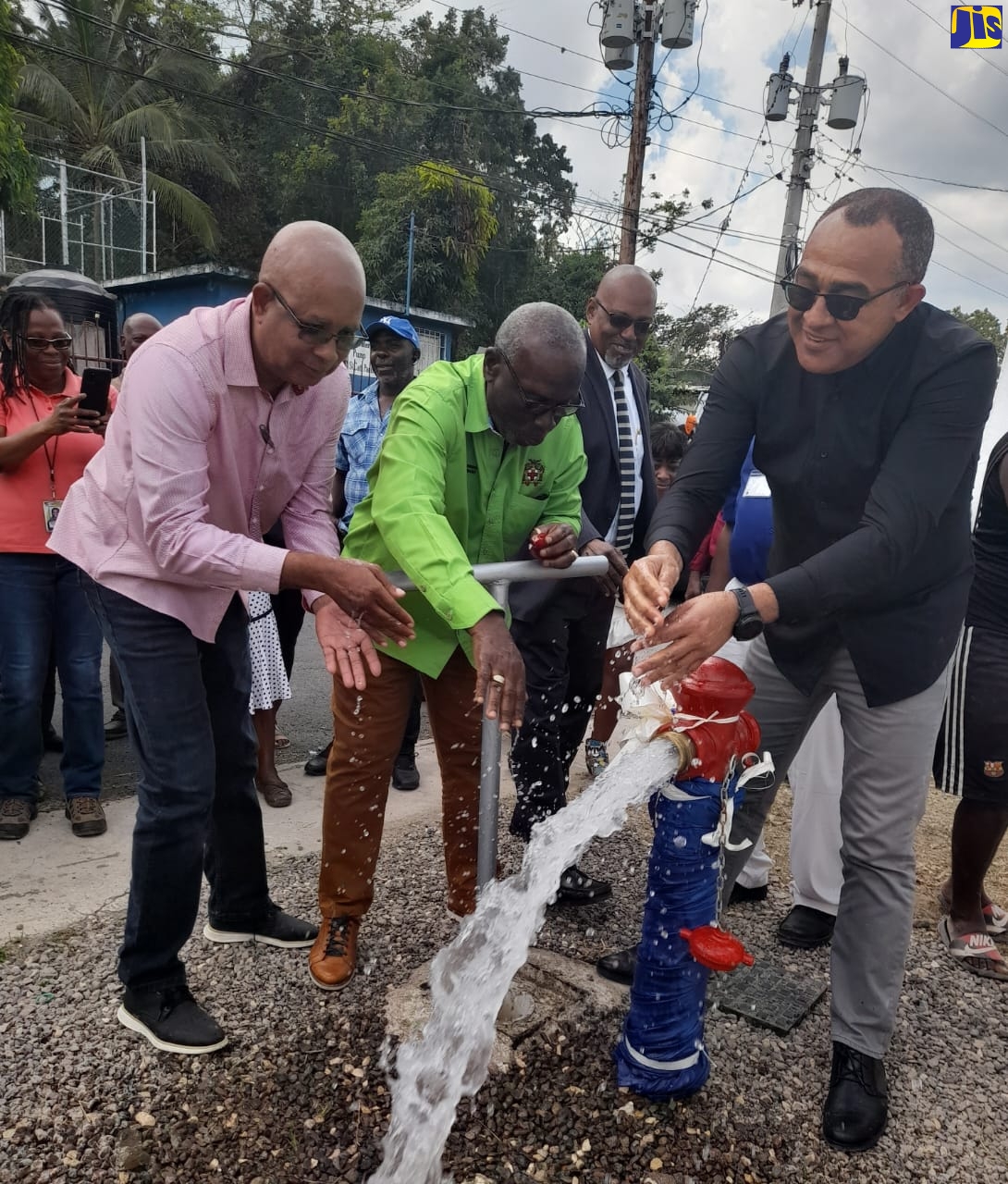Minister of Local Government and Rural Development, Hon. Desmond McKenzie (second left), officially commissions the Watermount water system in St. Catherine into operation on Wednesday (March 8). Others (from left) are Mayor of Spanish Town, Councillor Norman Scott (left); and Member of Parliament for St. Catherine West Central, Hon. Dr. Christopher Tufton.