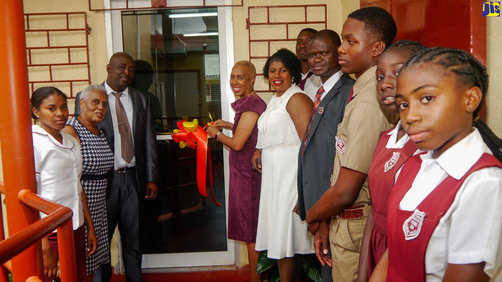 Minister of Education and Youth, Hon. Fayval Williams (fourth left), cuts the ribbon to officially open a new computer laboratory at Ferncourt High School in St. Ann on Sunday (March 26), following the 85th anniversary church service held at the St. Matthew’s Anglican Church in Claremont. Joining her are Chairman of the school board, Thelma Johill (second left); Principal, Sheldon Thomas (third left); Regional Director at the Ministry of Education and Youth – Region 3, Karlene Segre (fifth left); Education Officer at the Ministry of Education and Youth – Region 3, Wadyon Pryce (fourth right), along with students of  the institution. 