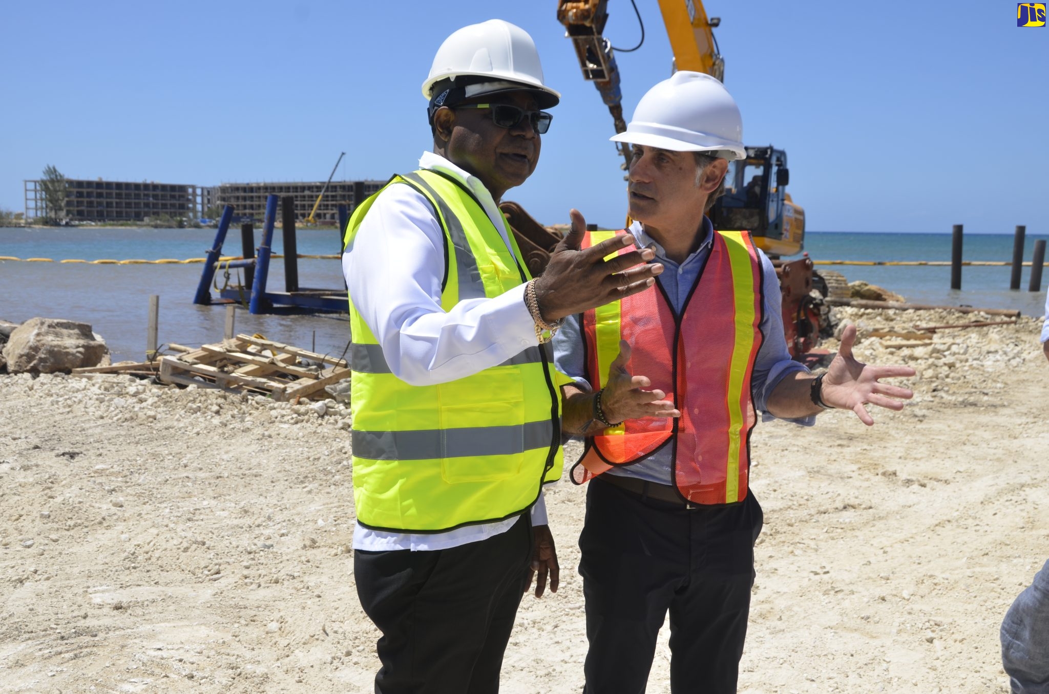 Minister of Tourism, Hon. Edmund Bartlett  (left), in discussion with owner of the Princess Resort in Hanover, Robert Cabrera, during a tour of resort