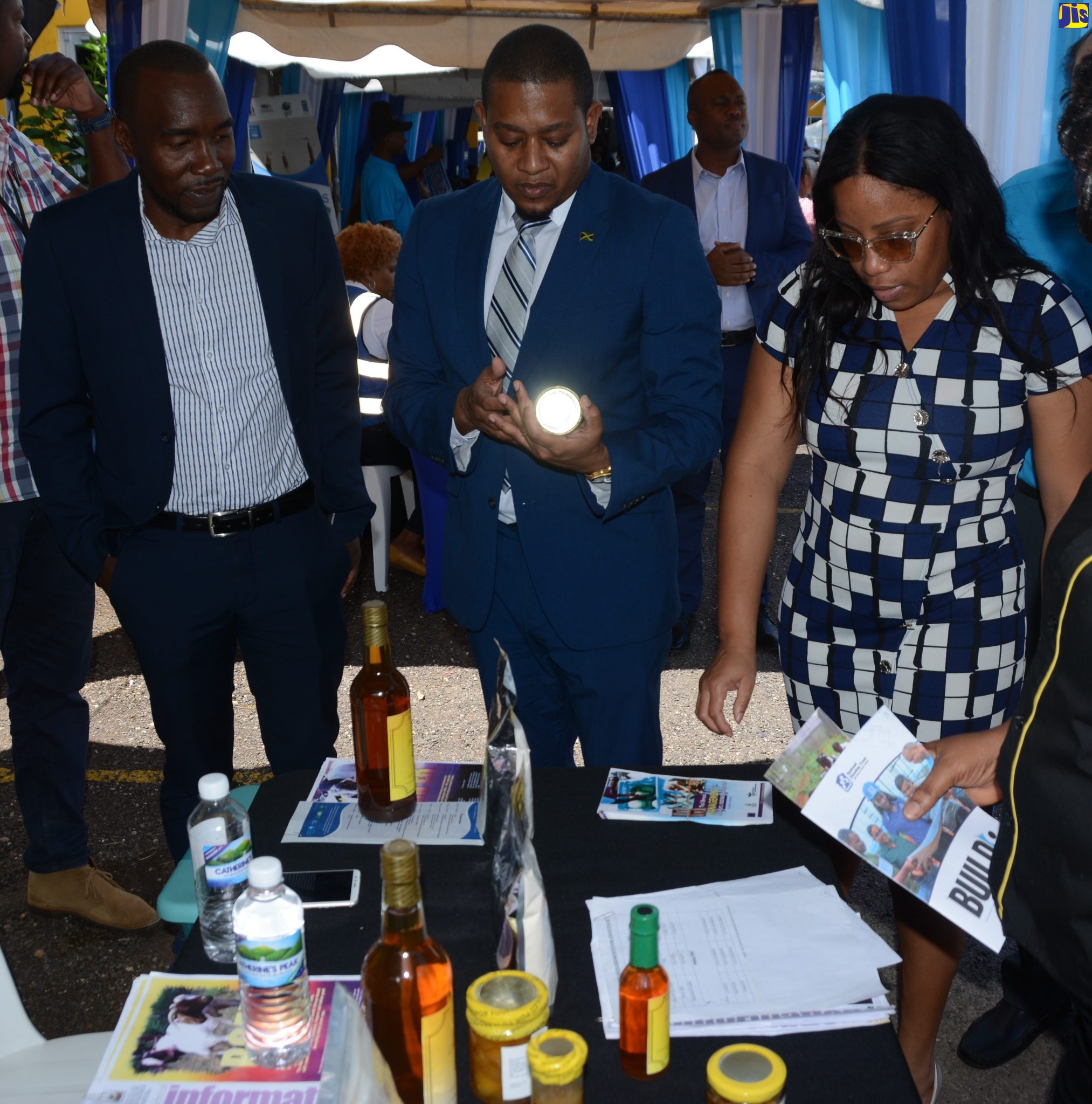 Minister Without Portfolio in the Office of the Prime Minister, Hon. Floyd Green (centre), looks at items on display at the Rural Agricultural Development Authority (RADA) booth. He is accompanied by Chief Technical Director (Water, Works, Investment) in the Ministry of Economic Growth and Job Creation, Yaneke Watson (left) and Councillor for the Brompton Division, Withney Smith-Currie. Occasion was World Water Day 2023 activities at the St. Elizabeth Technical High School (STETHS) on Wednesday, March 22.