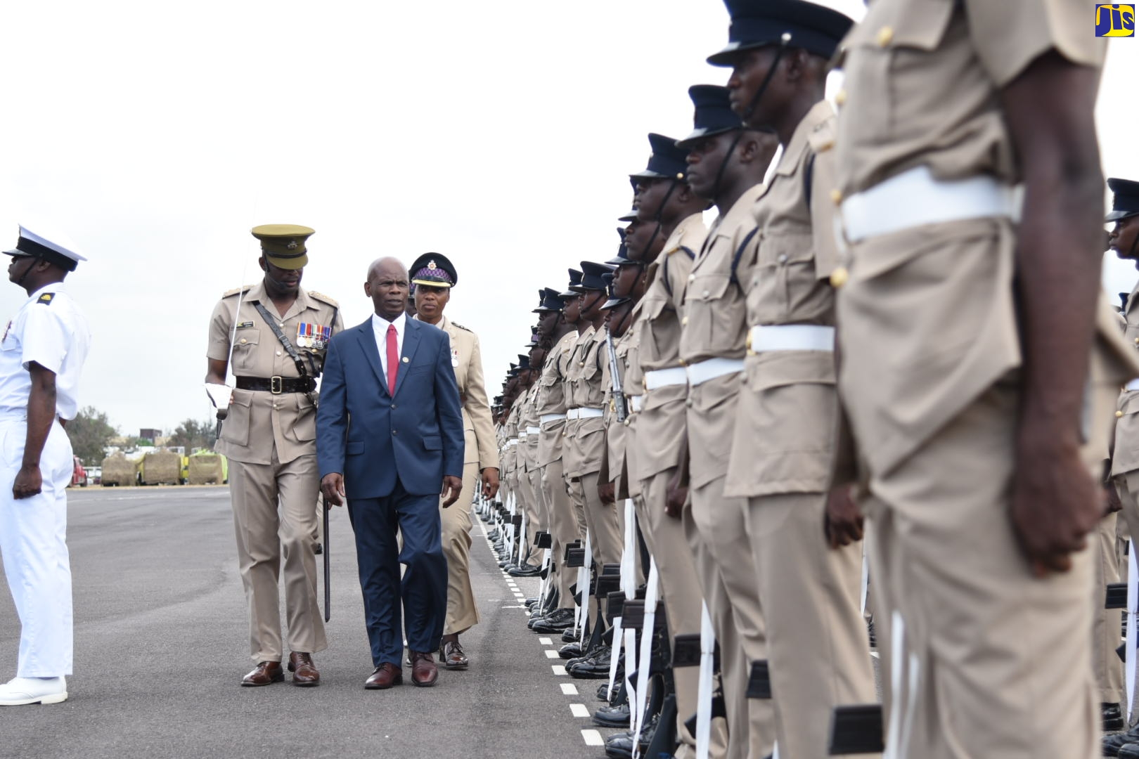 Custos of Kingston, Hon. Steadman Fuller (centre) inspects graduates of the Jamaica National Service Corps (JNSC) Intake 2022/01 during the Passing Out Parade on Friday (March 17) at Up Park Camp, Kingston. He is accompanied by Jamaica Defence Force (JDF) Capt. Easton Douglas (left), and and Commanding Officer, Lieutenant Colonel A. P. Henry.