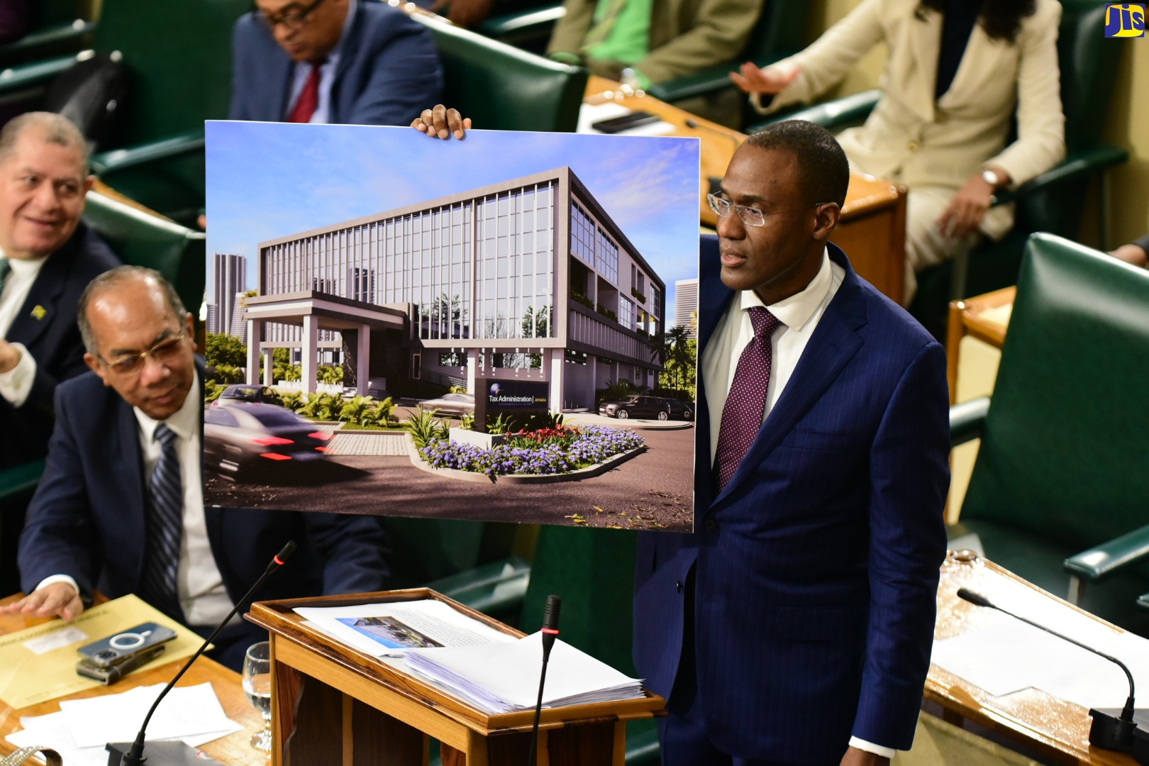 Minister of Finance and the Public Service, Dr. the Hon. Nigel Clarke, displays digitally generated image of the exterior of new tax to be built in Montego Bay, St. James, while opening the 2023/24 Budget Debate in the House of Representatives, on Tuesday (March 7).