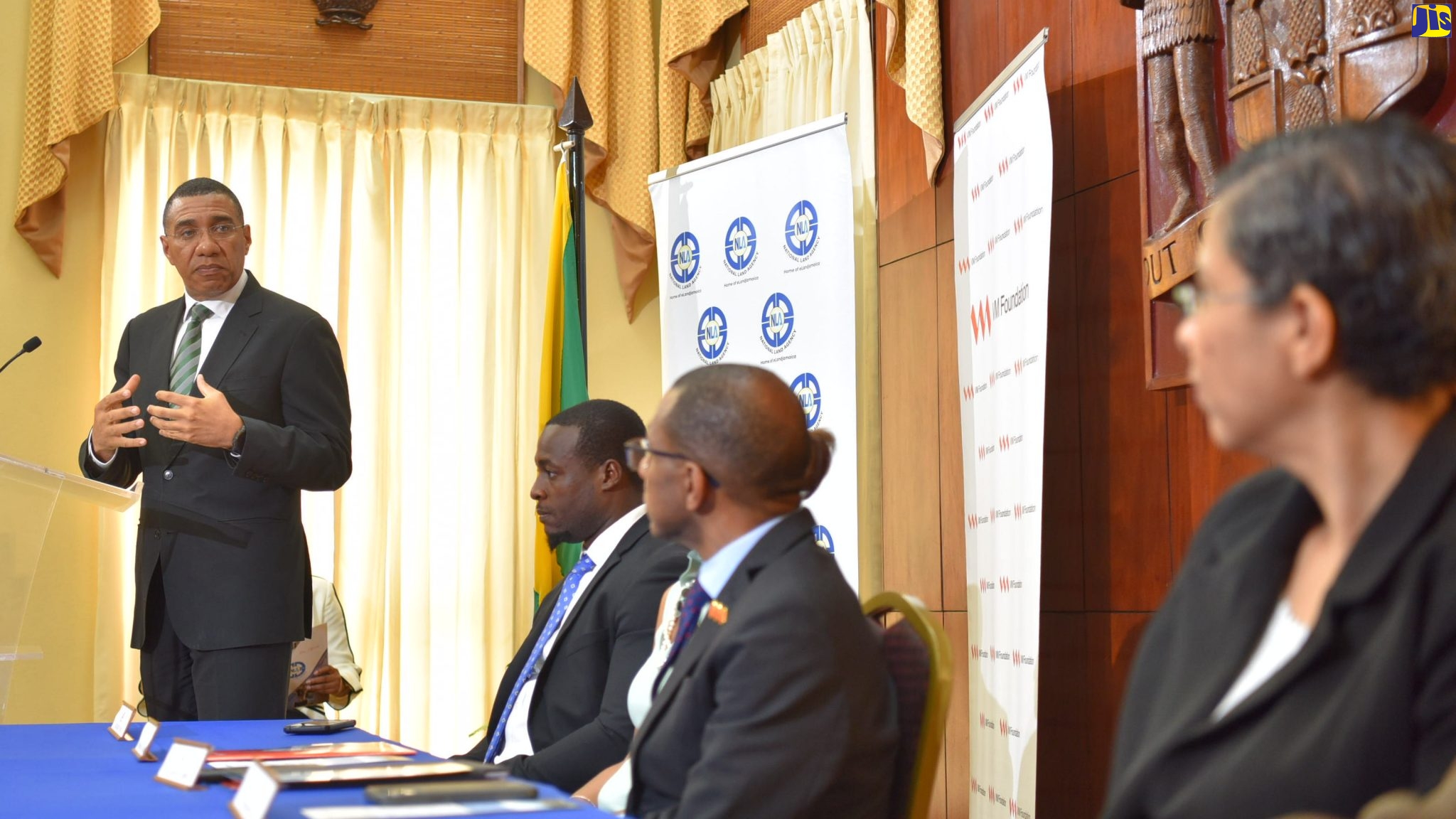 Prime Minister, the Most Hon. Andrew Holness, addressing a Memorandum of Understanding (MOU) Signing Ceremony between the Victoria Mutual (VM) Group, VM Foundation and the National Land Agency (NLA) at Jamaica House recently. Others (from left, seated) are Senior Director, Land Administration and Management (Acting), NLA, Nickoy Young; Chief Executive Officer (CEO), VM Foundation, Samantha Charles; President and CEO, VM Group, Courtney Campbell; CEO and Commissioner of Lands, NLA, Cherise Walcott. 