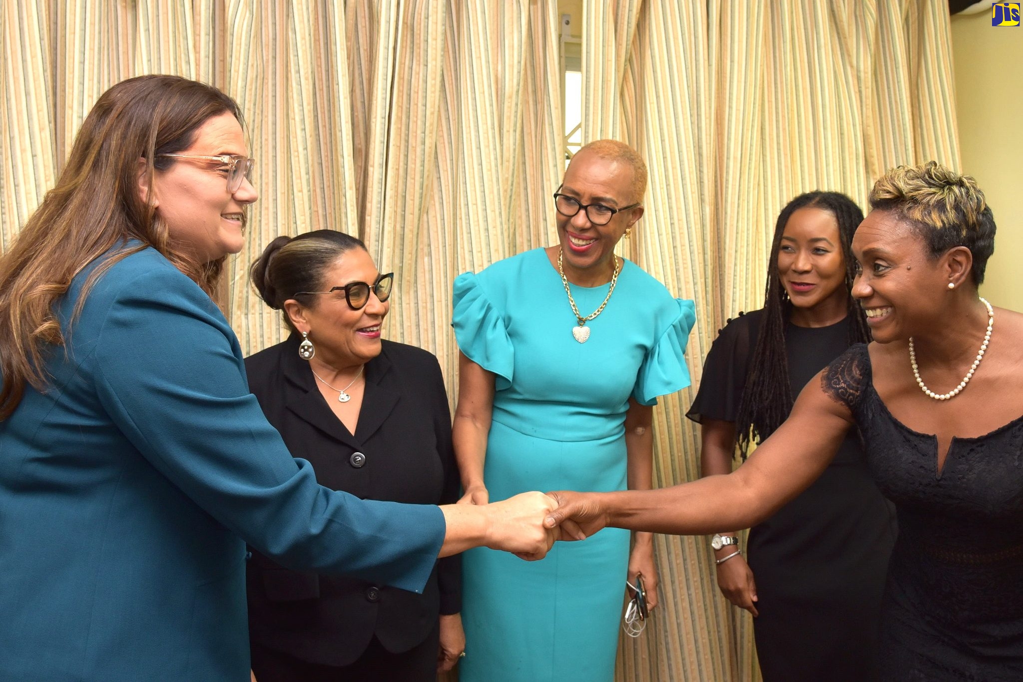 Minister of State in the Ministry of Health and Wellness and Member of Parliament (MP) for St. Andrew West Rural, Hon. Juliet Cuthbert Flynn (right), shakes hands with Speaker of the House of Parliament of the Cayman Islands, Katherine Ebanks-Wilks (left). Looking on (from second left) are:  Speaker of the House of Representatives, Marisa Dalrymple Philibert; Minister of Education and Youth and MP for St. Andrew Eastern, Hon. Fayval Williams; and MP for Trelawny Northern, Tova Hamilton. Ms. Ebanks-Wilks met with female Parliamentarians at Gordon House on March 9. 