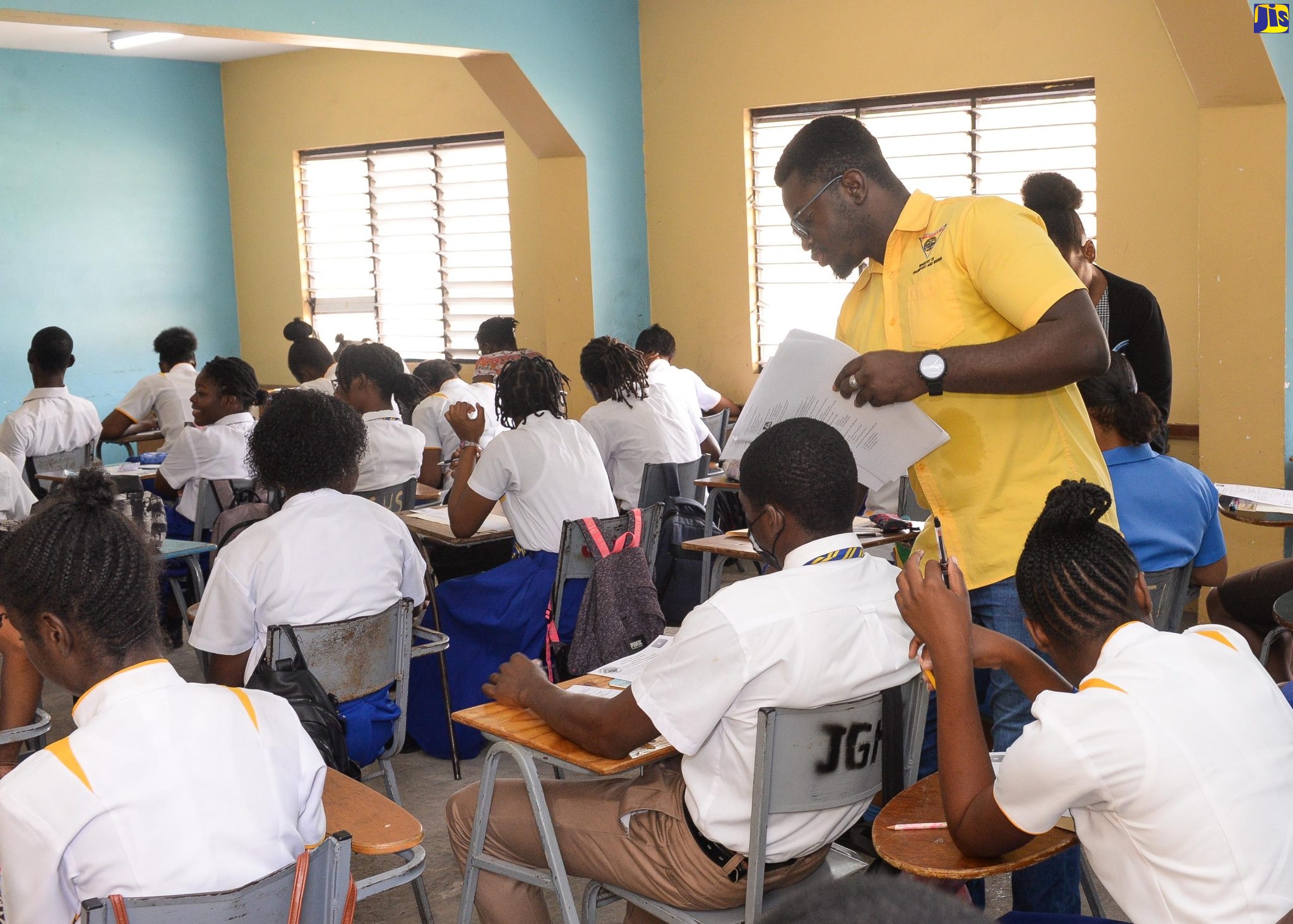 Information Officer at the Road Safety Unit (RSU), Dontae Matthews (second right), assists students during a recent road-safety examination at Jonathan Grant High School in Spanish Town, St. Catherine.