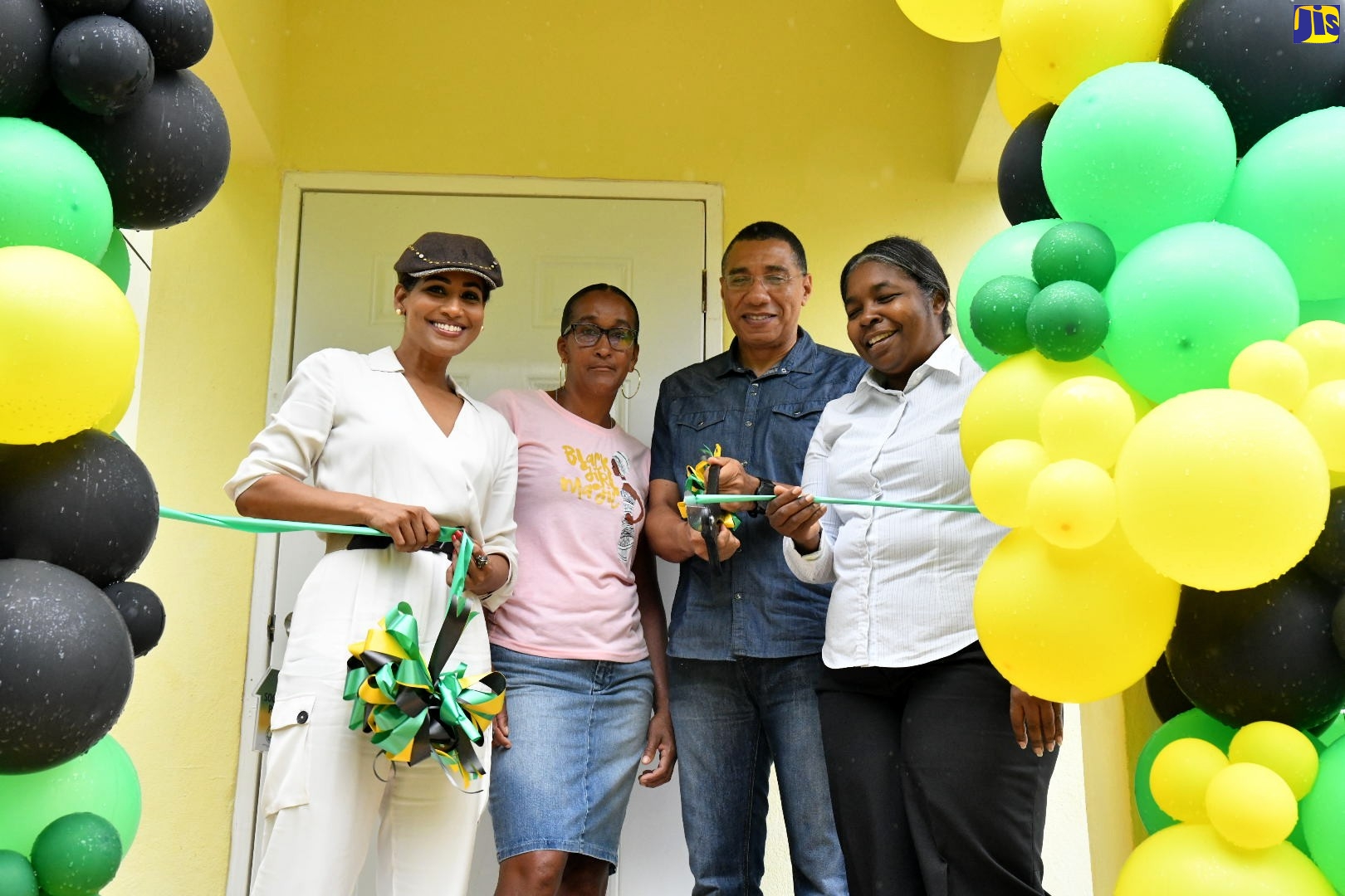 Prime Minister, the Most Hon. Andrew Holness (second right), is joined by (from left) Member of Parliament, St. Ann South Eastern, Lisa Hanna; New Social Housing Programme (NSHP) beneficiary, Stacey Roberts; and Chair, Housing, Opportunity, Production and Employment (HOPE) Project Oversight Committee, Judith Robb-Walters, in cutting the ribbon to officially handover a one-bedroom unit, built under the NSHP in York District, Bensonton, St. Ann, on Friday (April 21).
