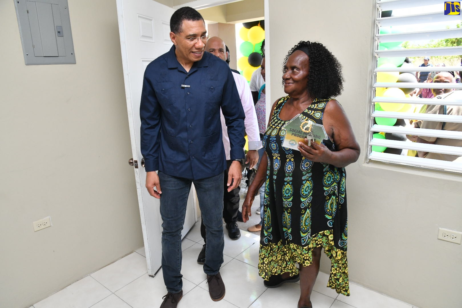 Prime Minister, the Most Hon. Andrew Holness (left) steps inside the three-bedroom house that was handed over to Lousie Williams (right) in Albion Meadows, St. Thomas today (April 28). Ms. Williams received the unit under the New Social Housing Programme (NSHP).